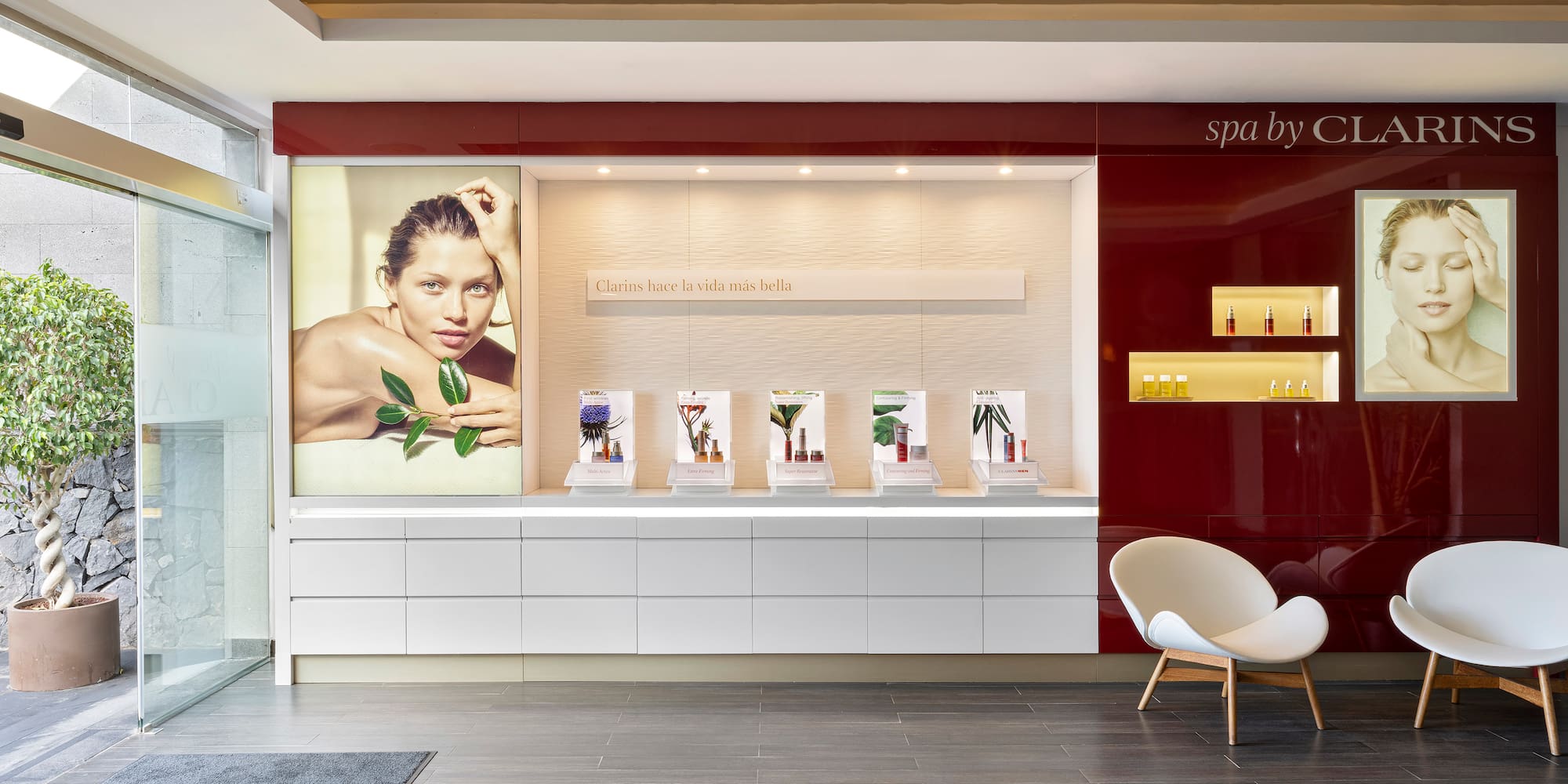 a room with a red wall and a white chair