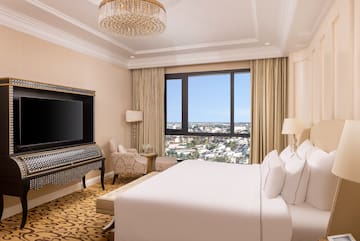 a room with a large bed and a piano