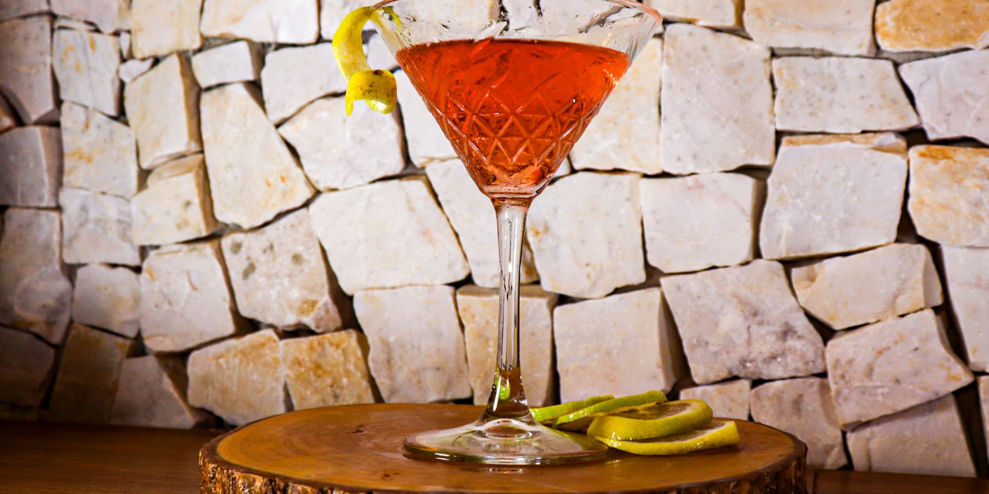 a glass with a drink on a wooden surface