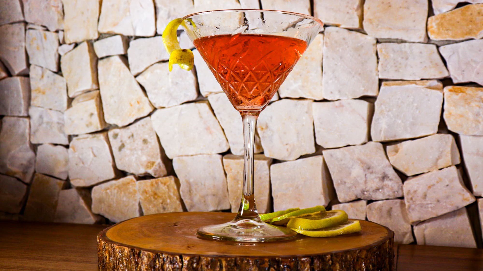 a glass with a drink on a wooden surface