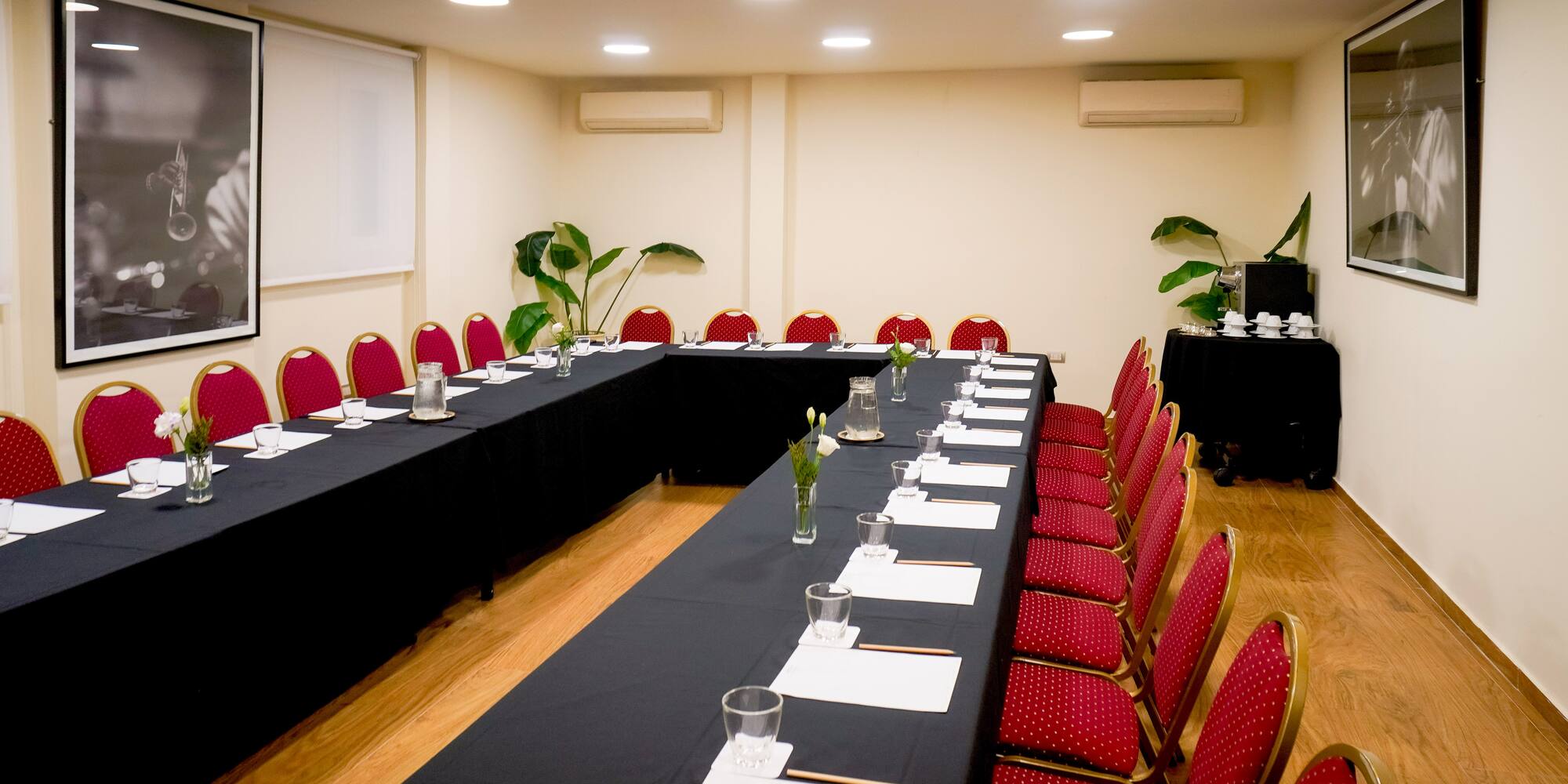 a room with long tables and chairs