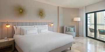 a bedroom with a bed and a chair