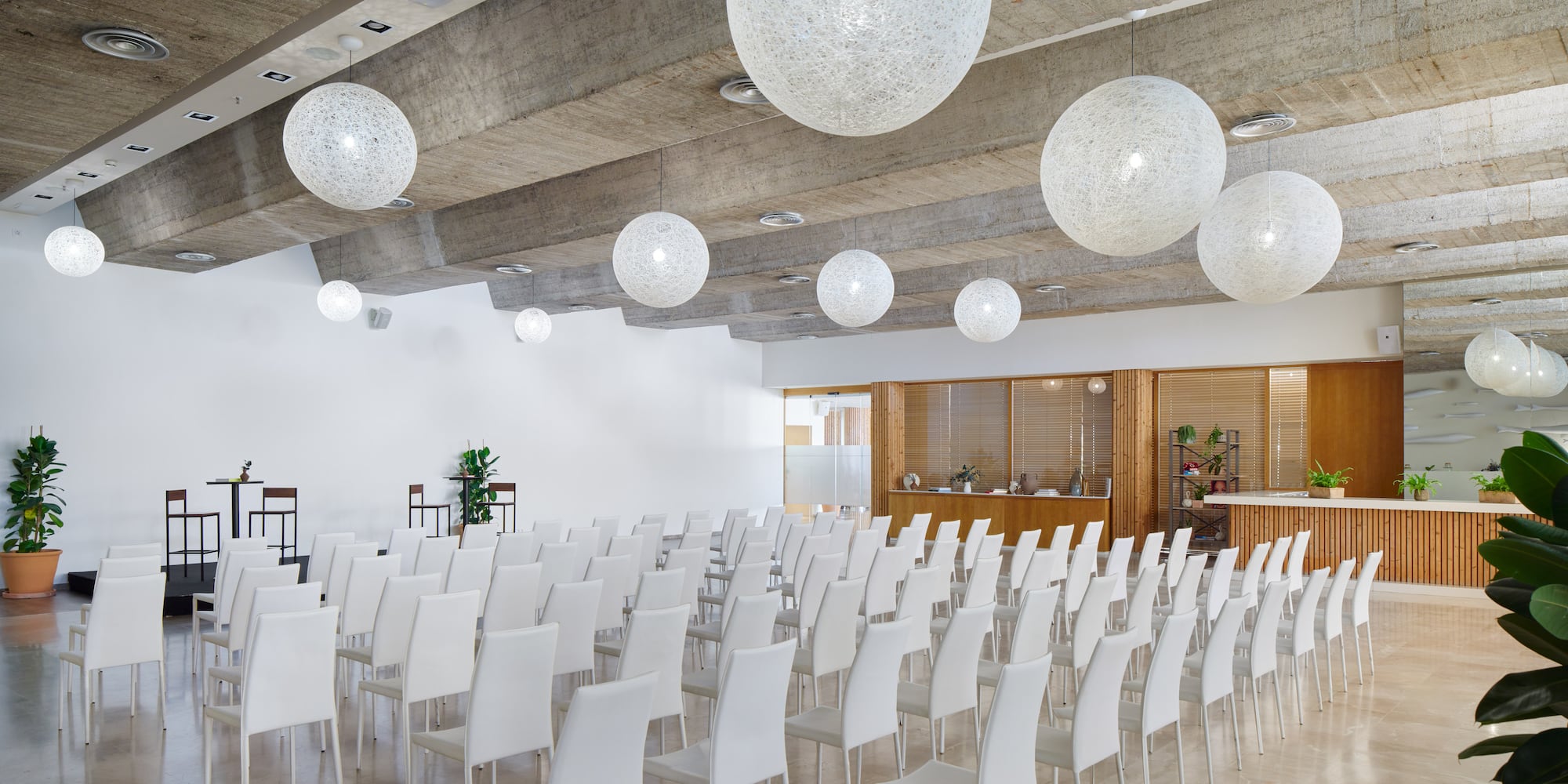 a room with white chairs and white lights
