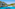 Crystal clear turquoise bay, white sand beach, and rocky pine cliffs.