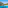 Turquoise water beach in a rocky Mediterranean cove with pine trees.