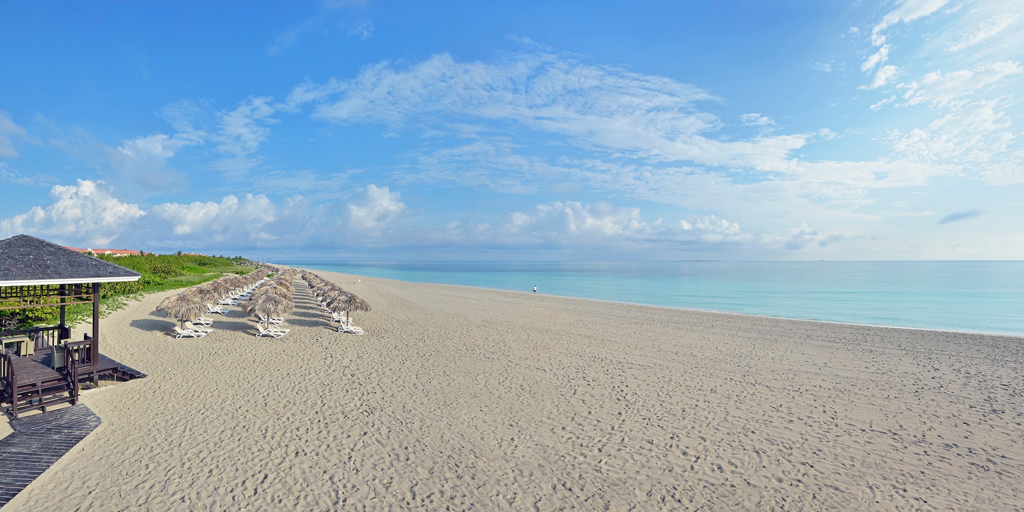 a beach with umbrellas and chairs