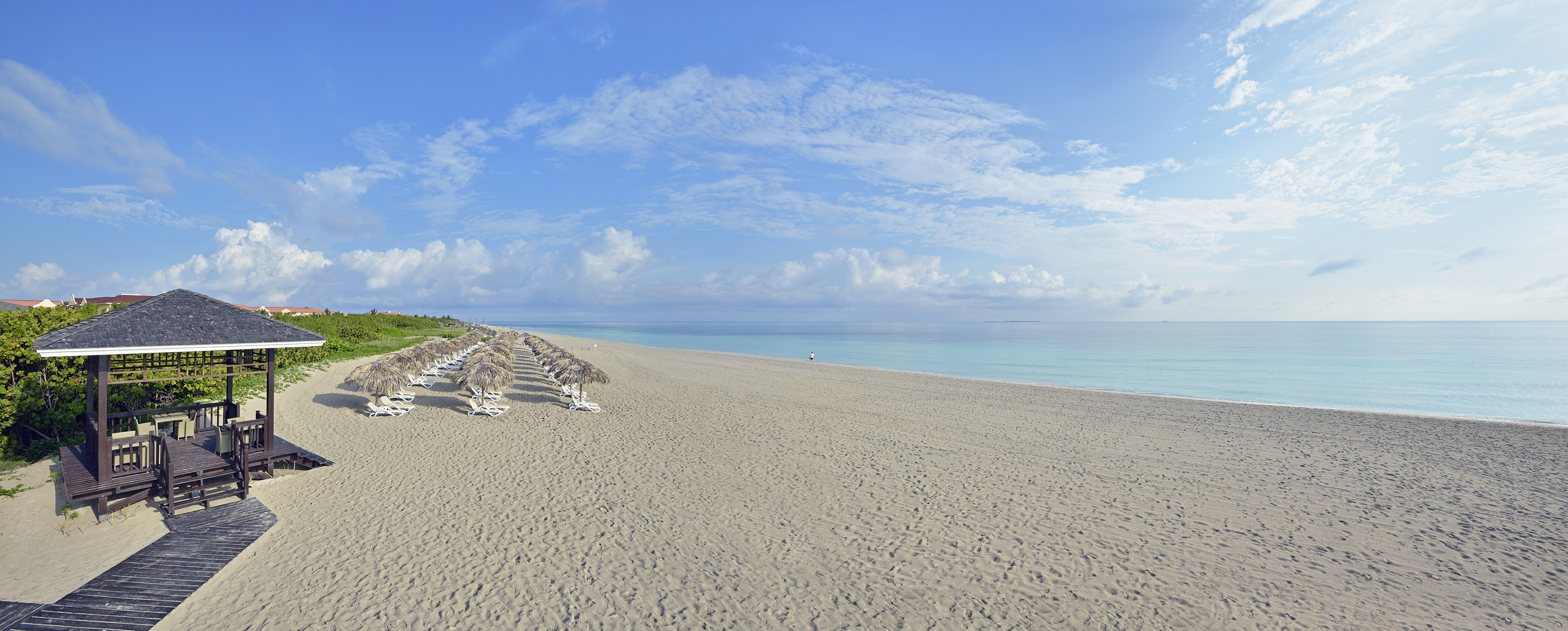 a beach with umbrellas and chairs