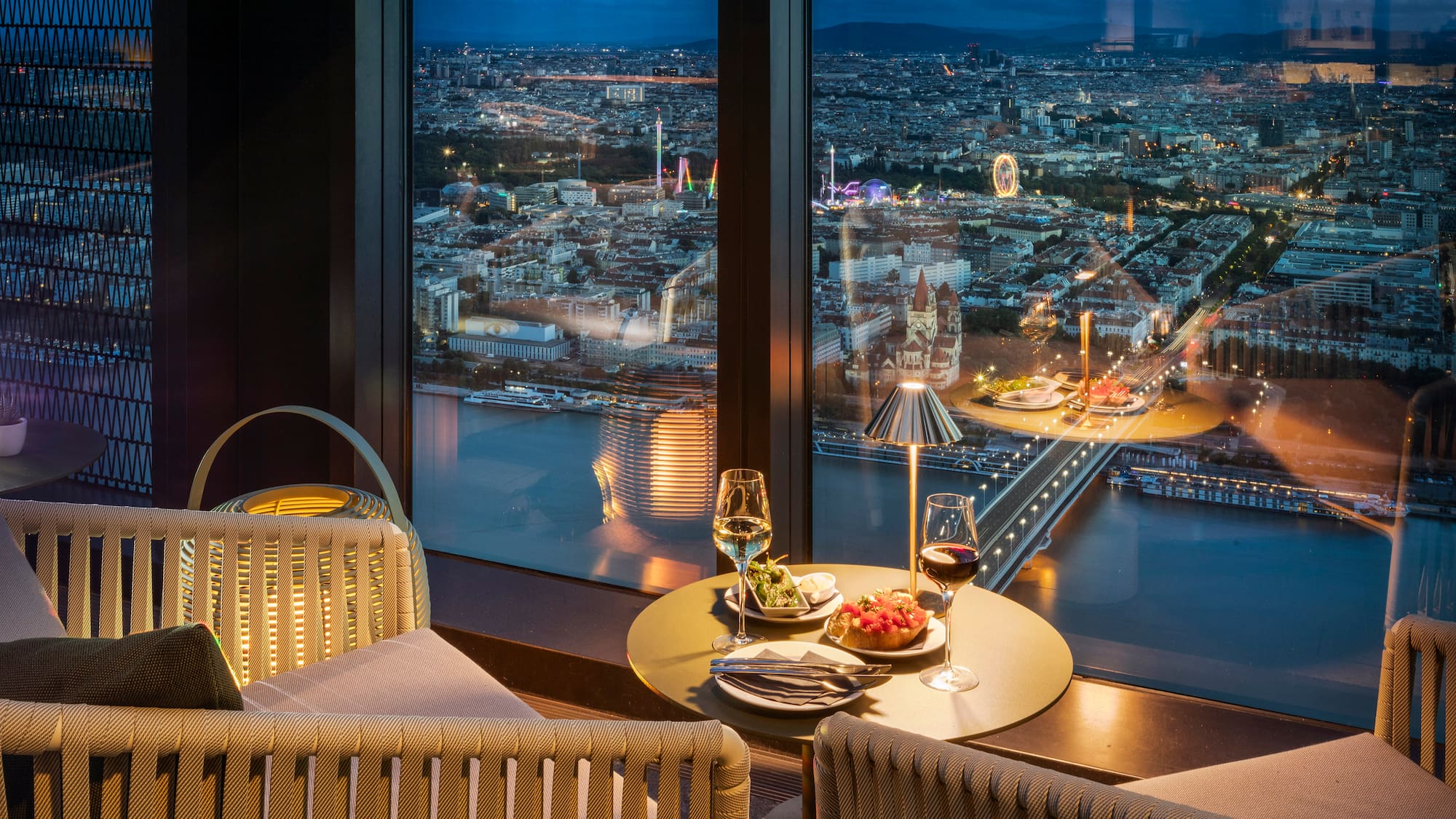 a table with food and wine in front of a window