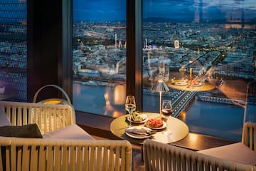 a table with food and wine in front of a window