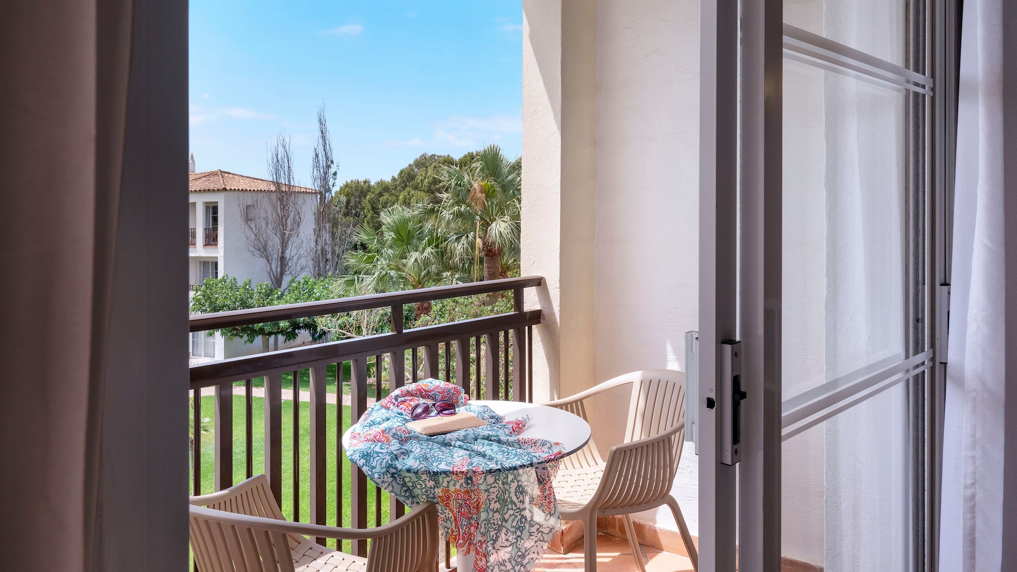 a patio with chairs and table