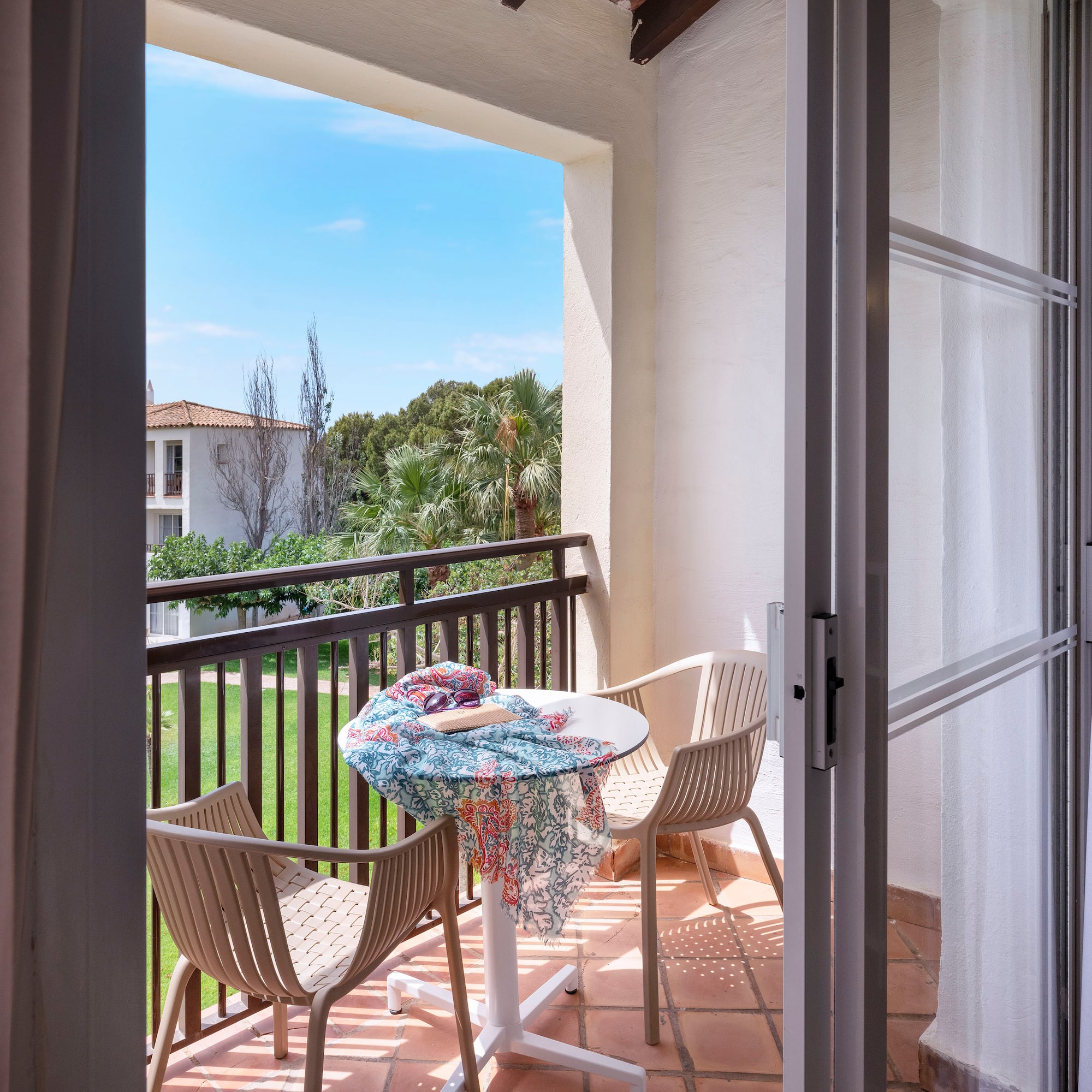a patio with chairs and table