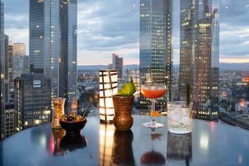 a table with drinks on it and a city view