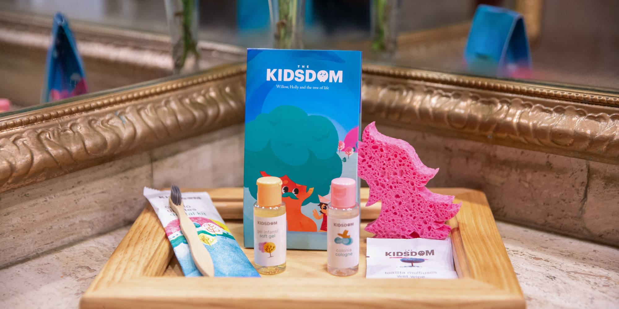 a wooden tray with a small bottle of liquid and a sponge