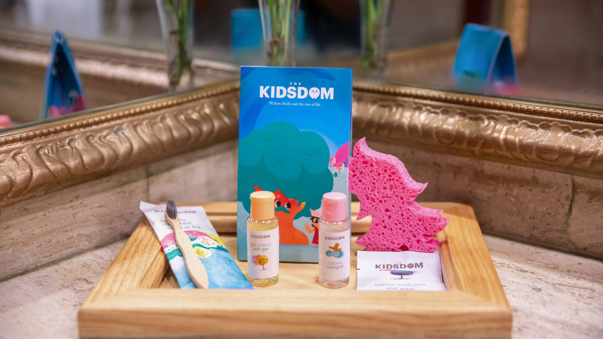 a wooden tray with a small bottle of liquid and a sponge
