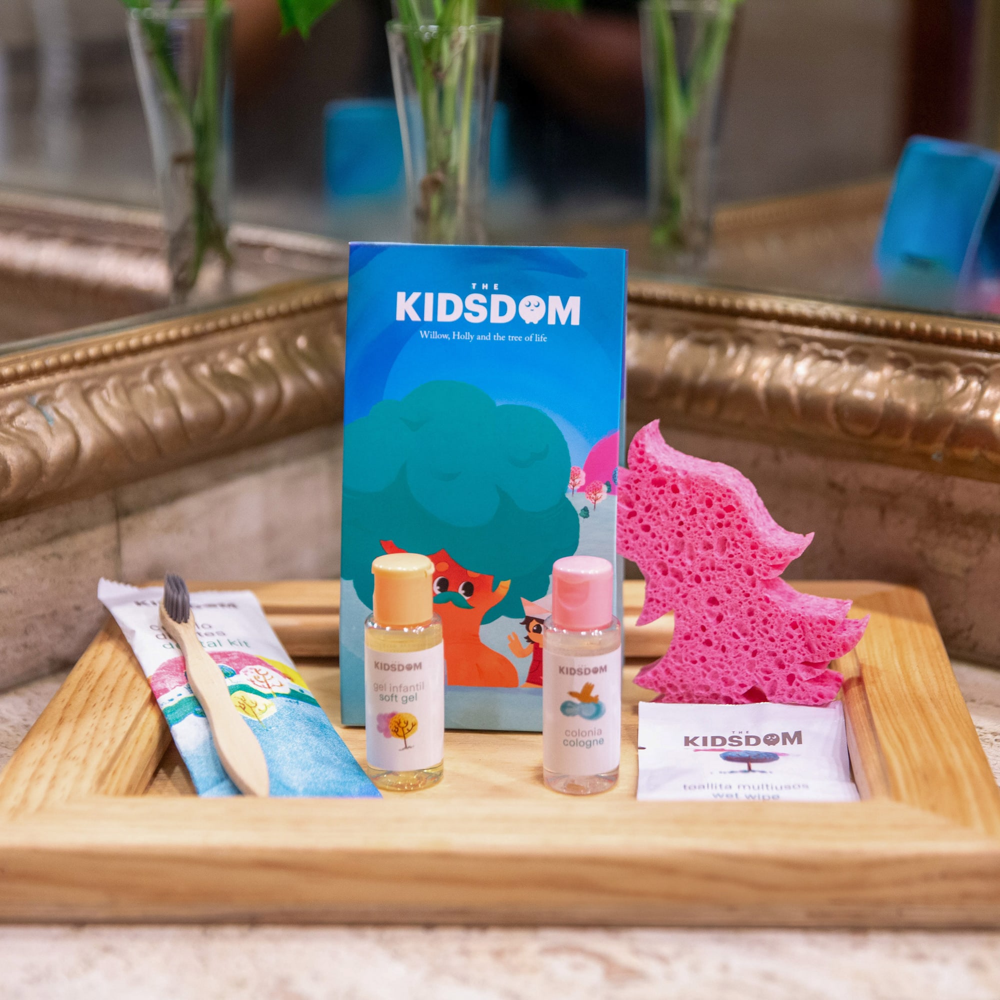a wooden tray with a small bottle of liquid and a sponge