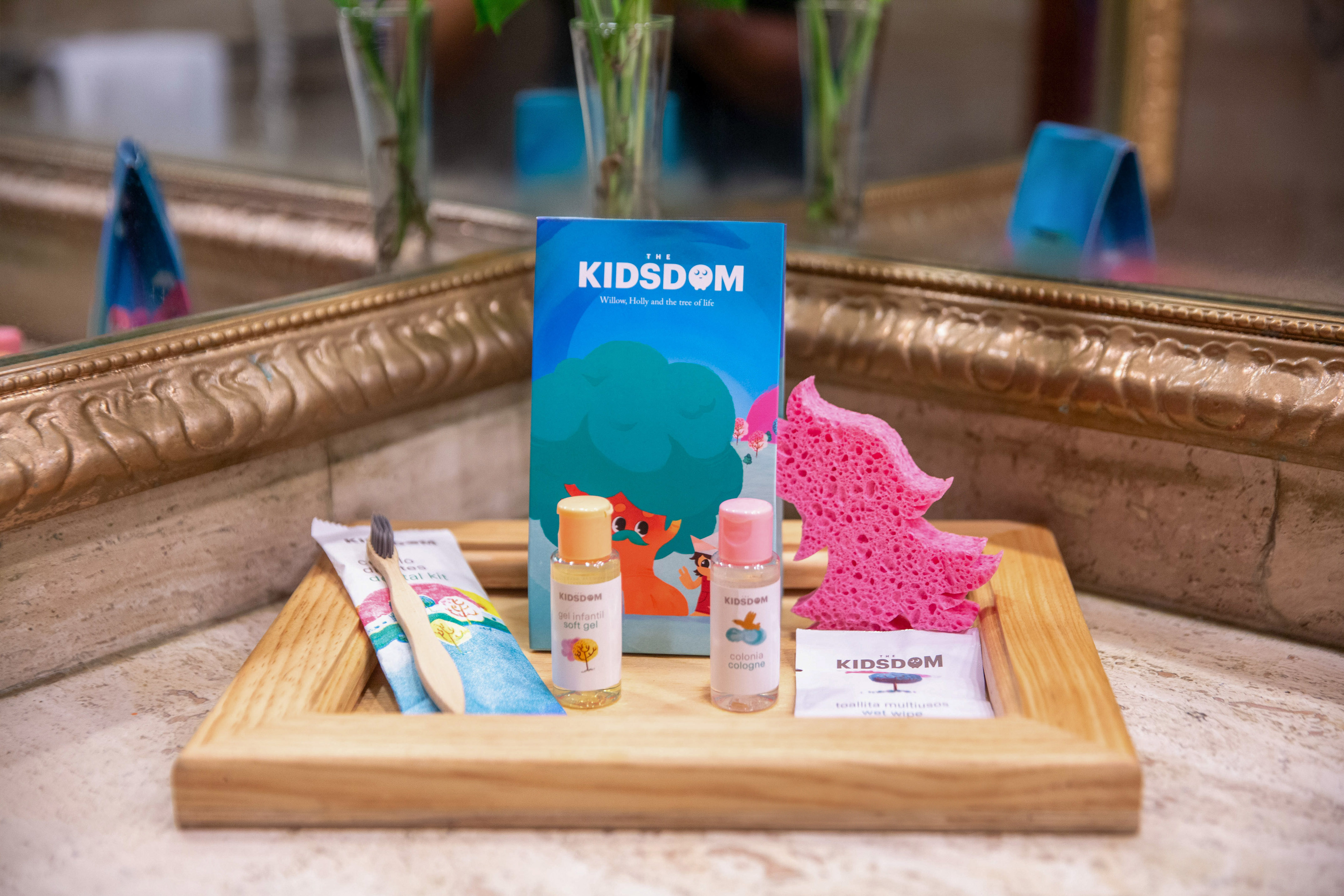 a wooden tray with a small bottle of liquid and a sponge