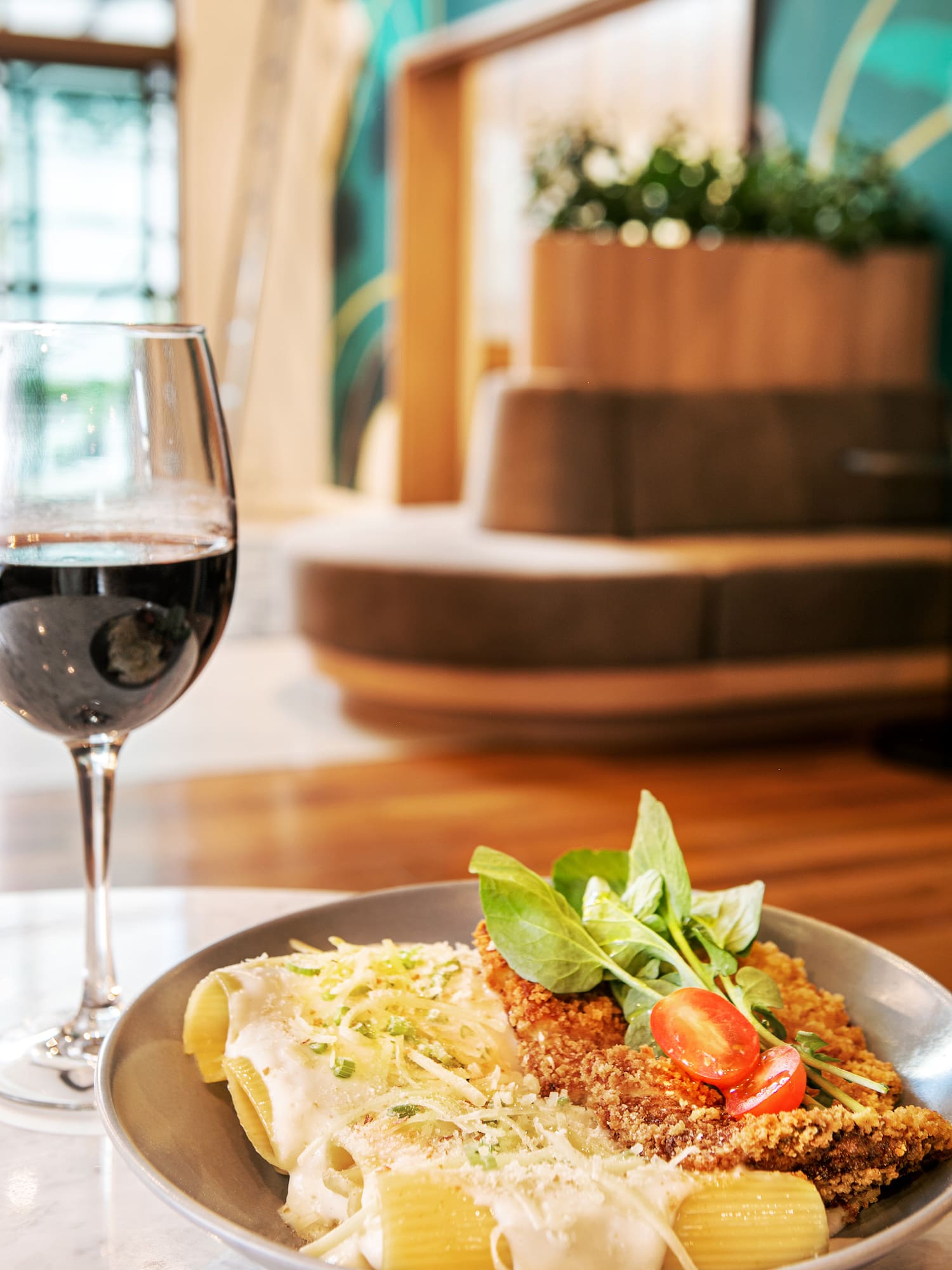 a plate of food and a glass of wine