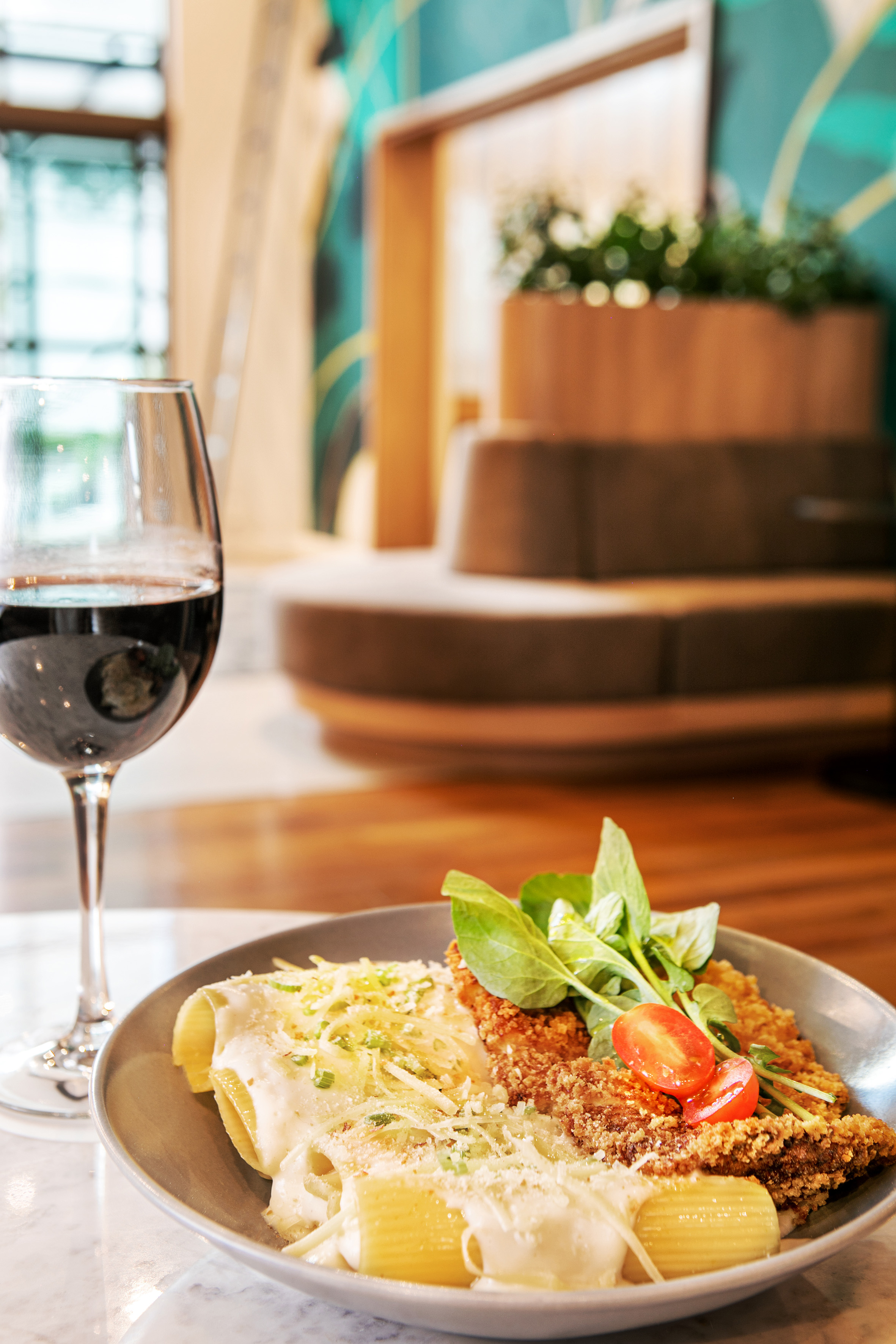 a plate of food and a glass of wine