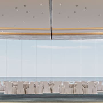 a room with white chairs and tables