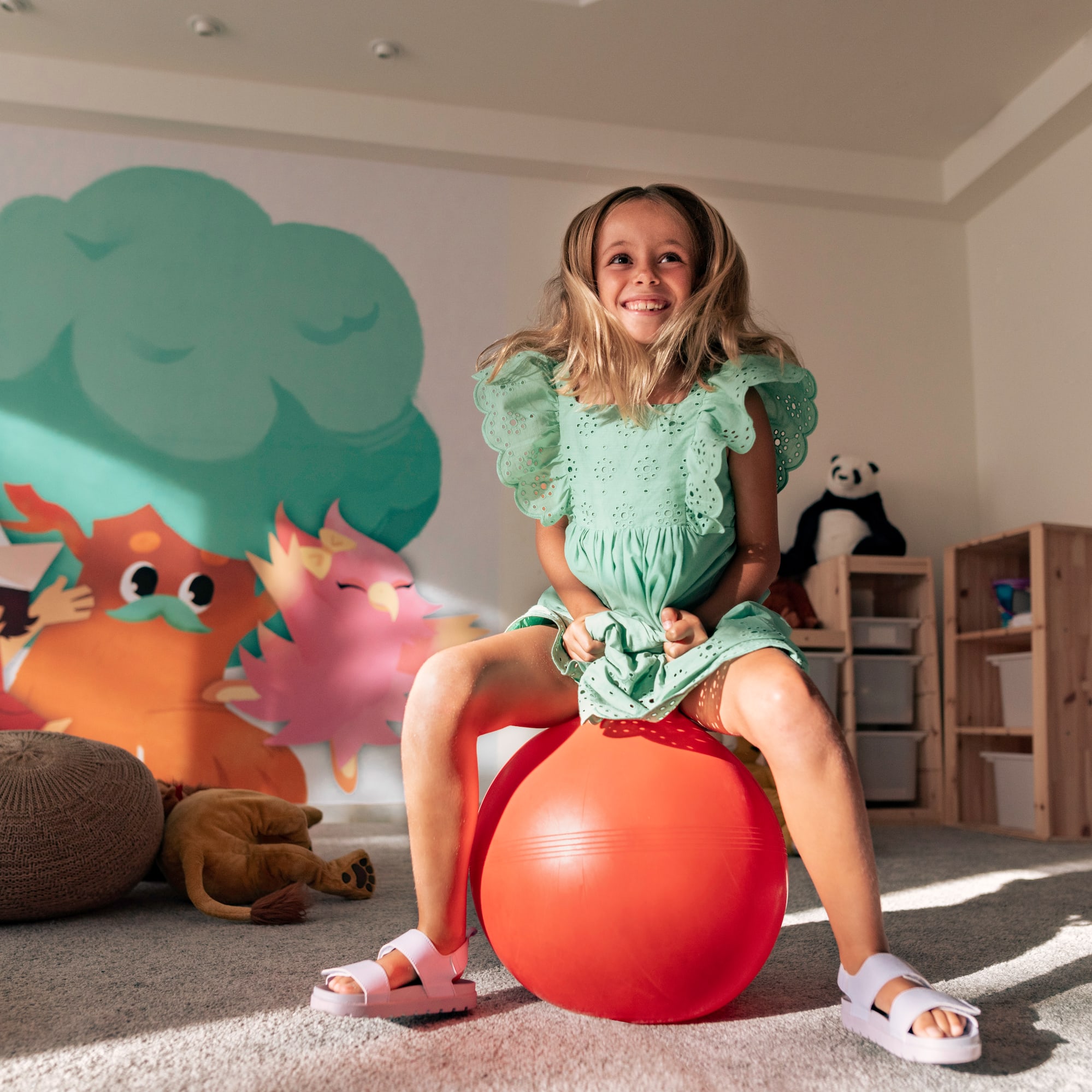a girl sitting on a large ball