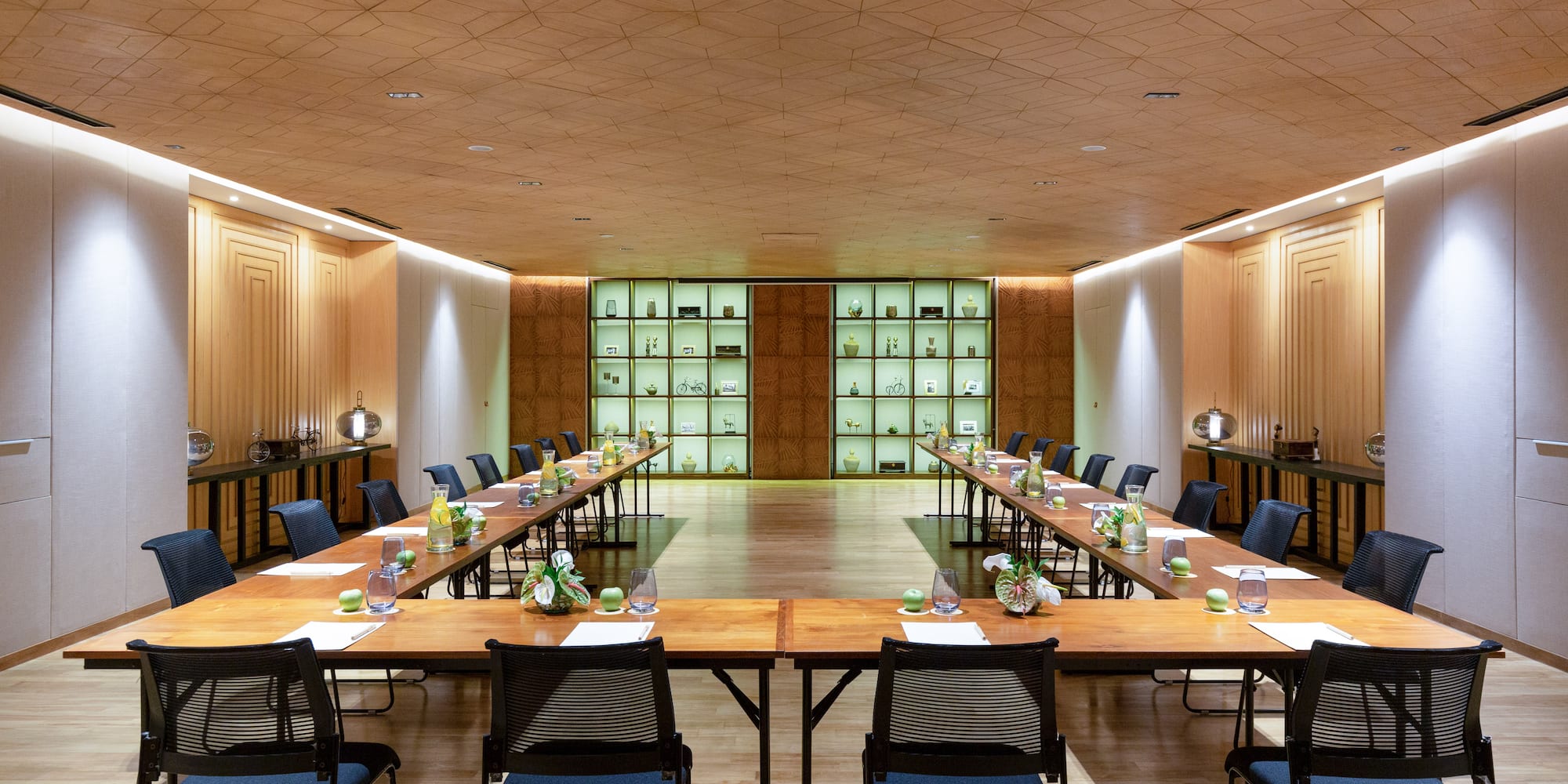 a room with long tables and chairs