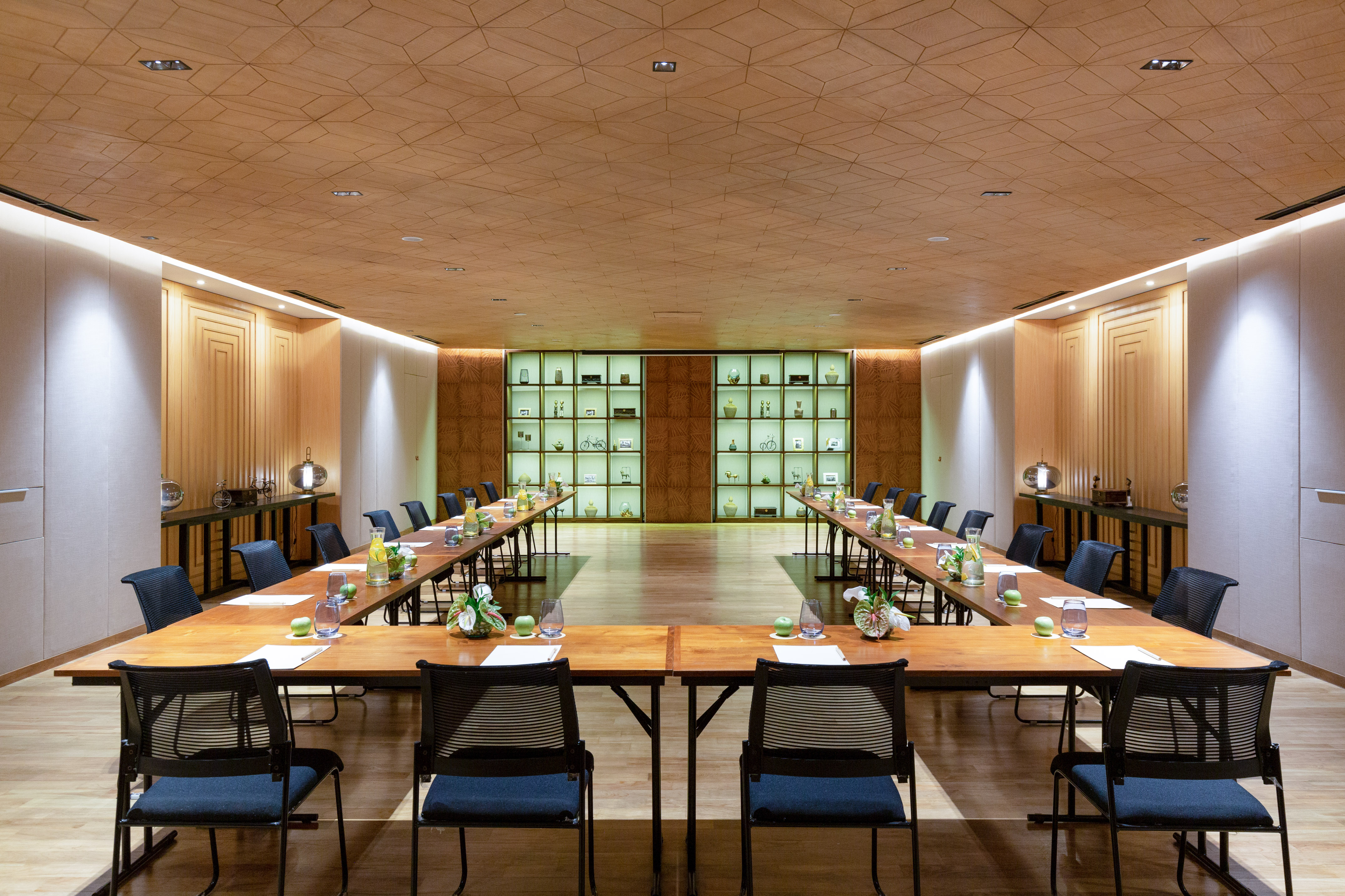 a room with long tables and chairs