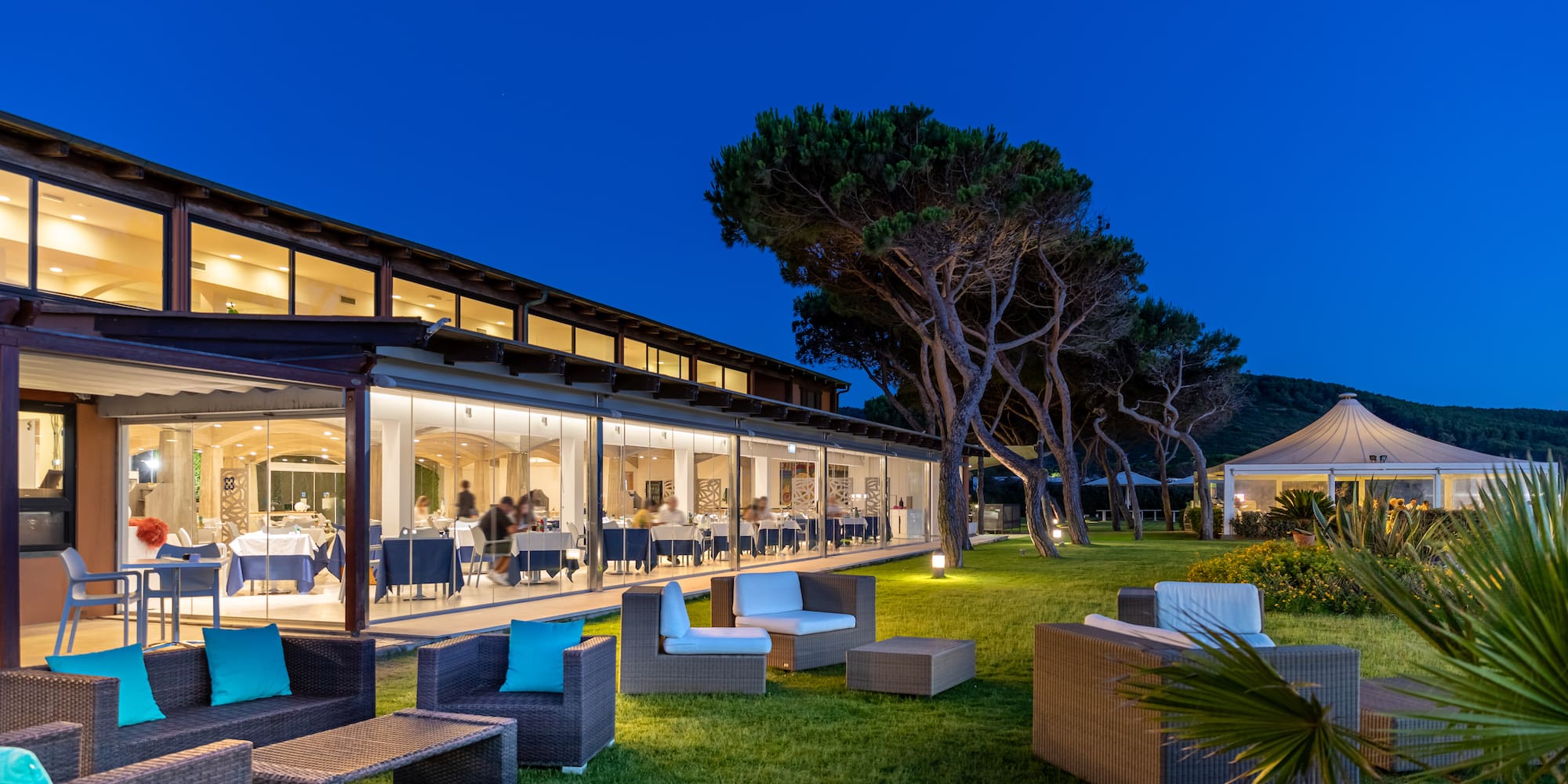 a building with a glass wall and chairs