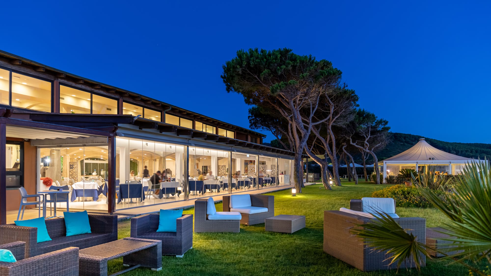 a building with a glass wall and chairs