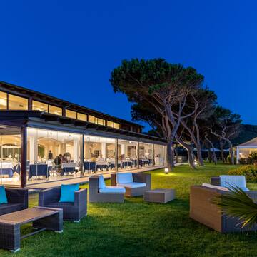 a building with a glass wall and chairs