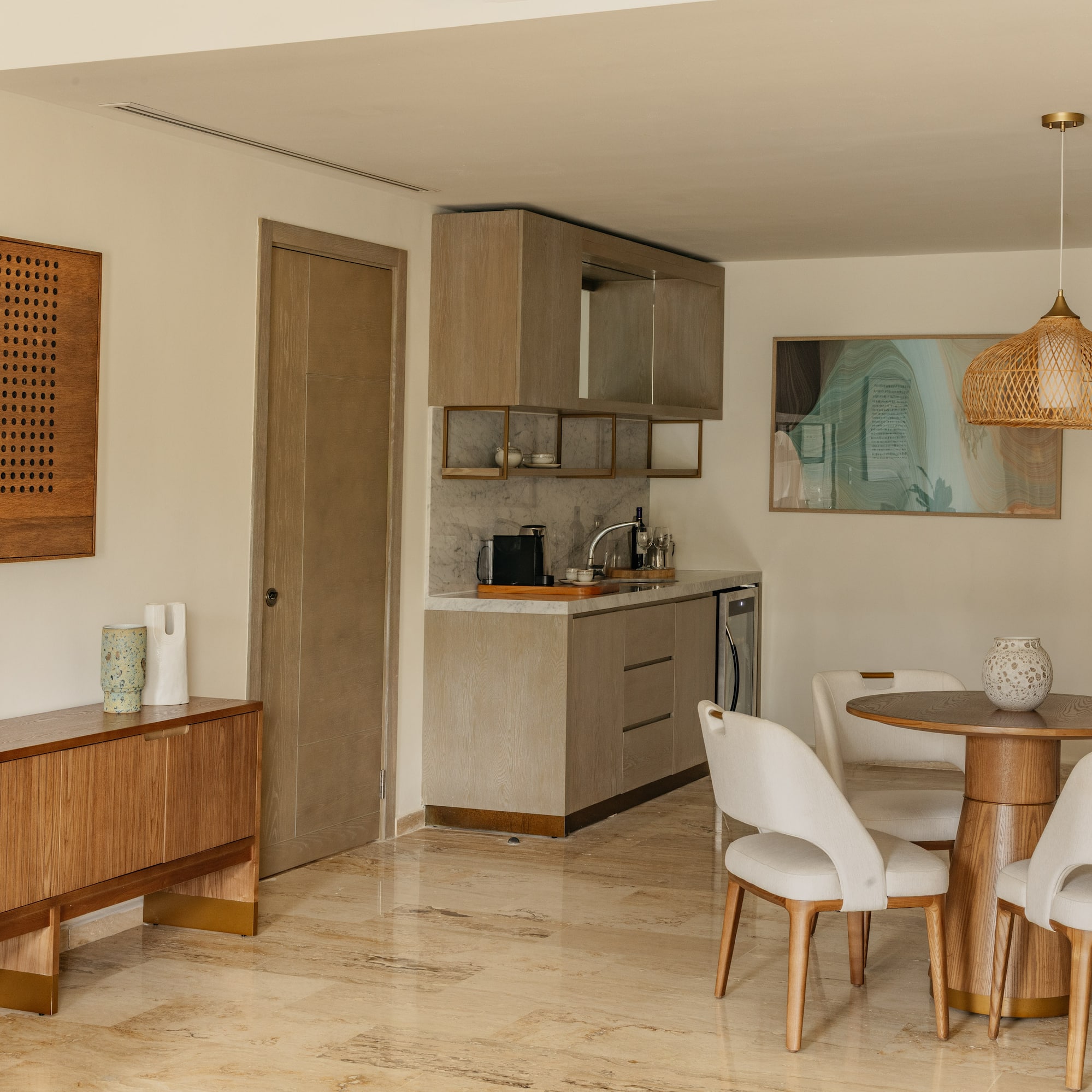 Modern apartment interior with kitchenette, dining set, and wood furniture.