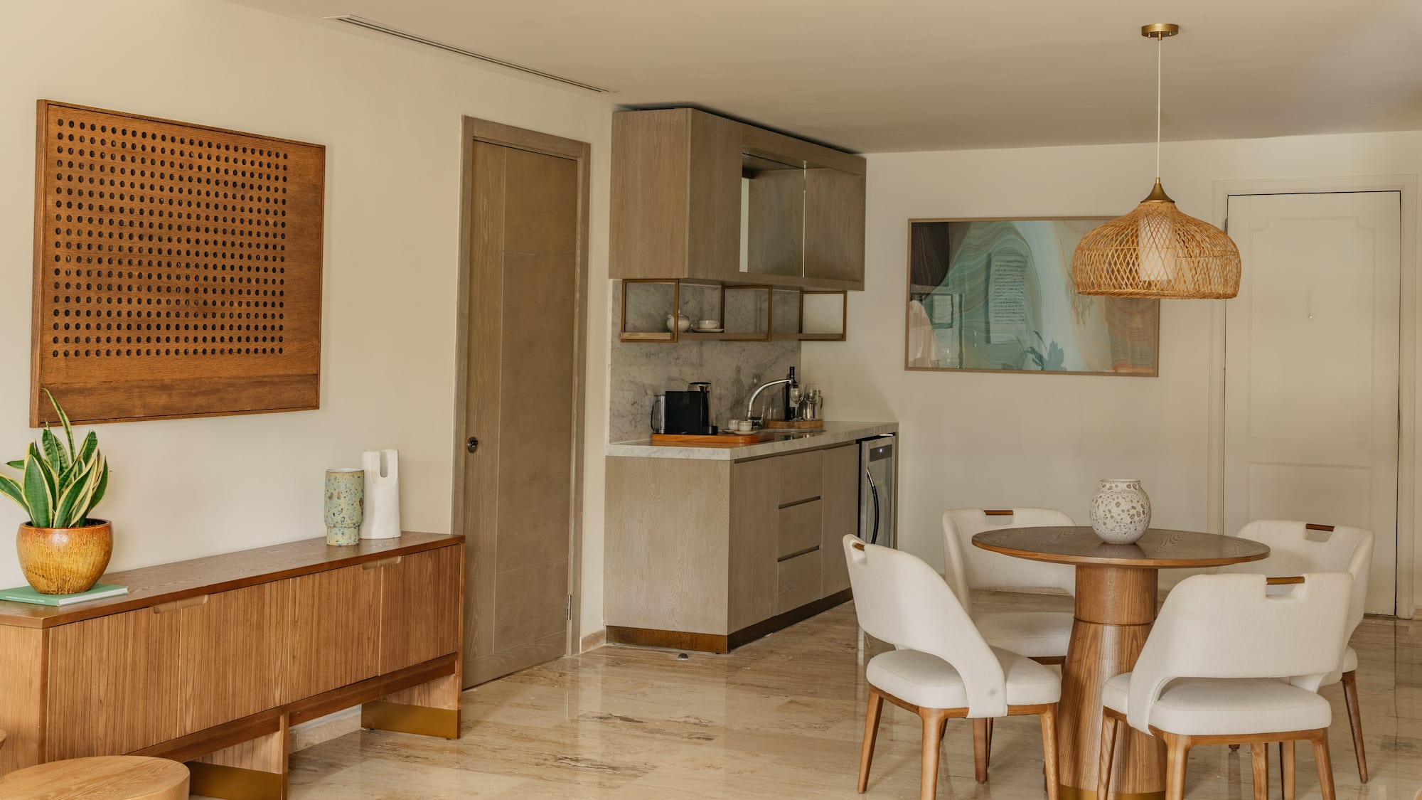 Modern apartment interior with kitchenette, dining set, and wood furniture.