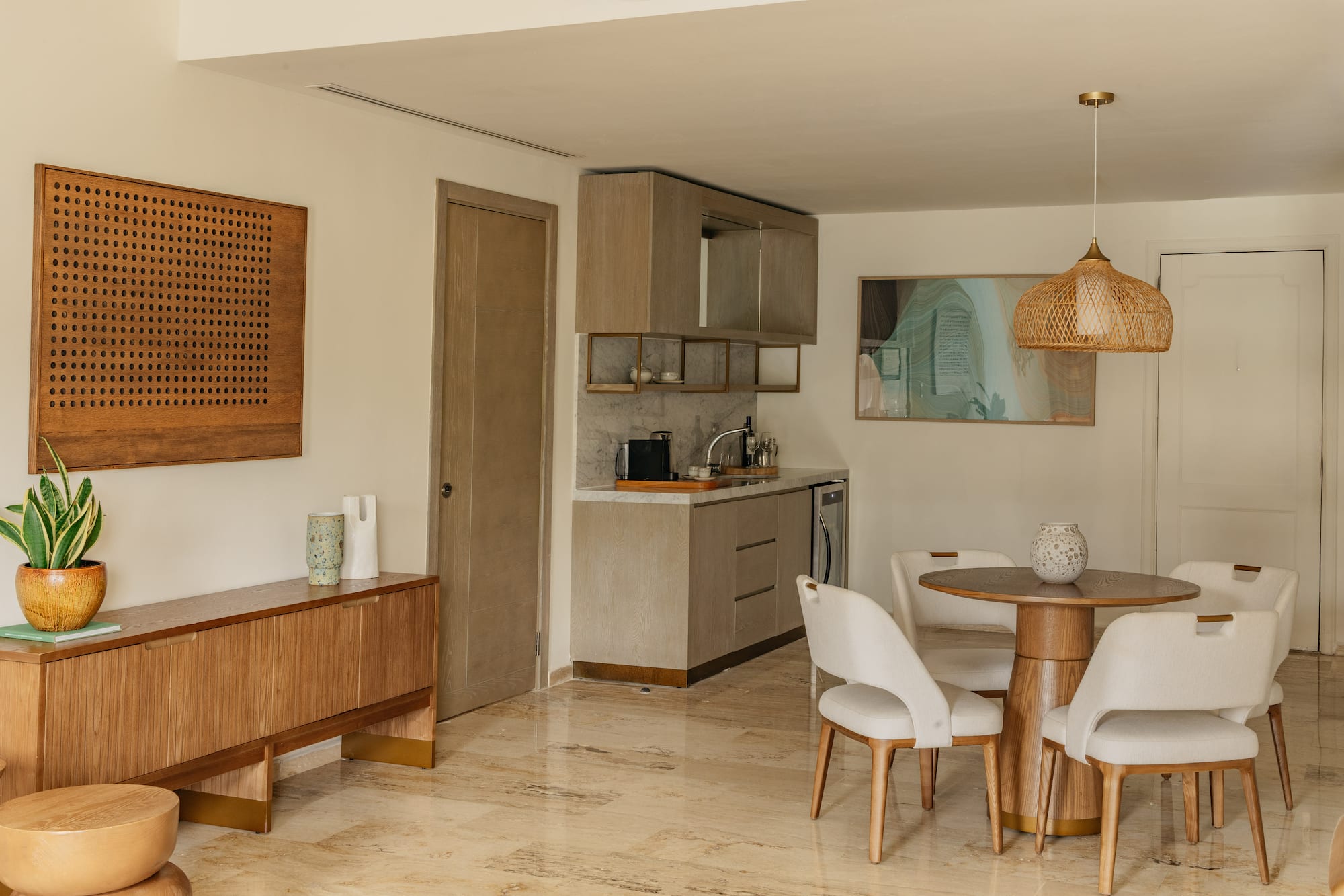 Modern apartment interior with kitchenette, dining set, and wood furniture.