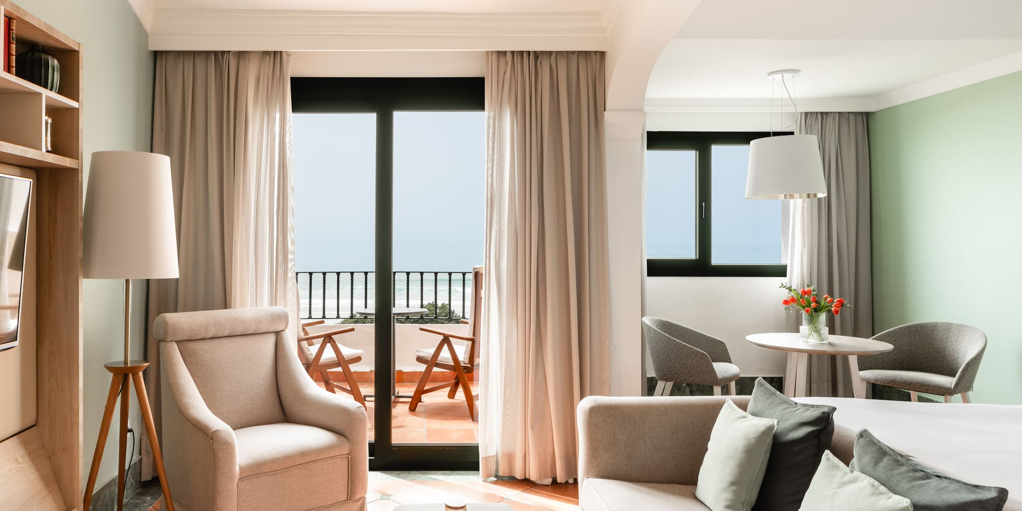 a living room with a couch and chairs