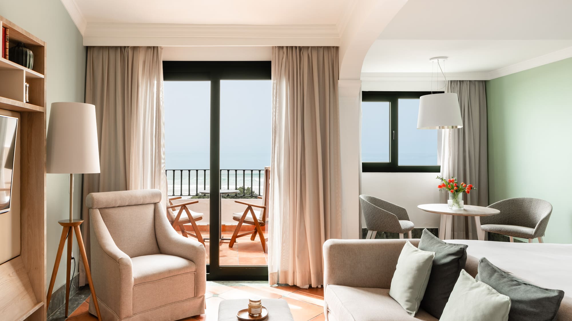 a living room with a couch and chairs