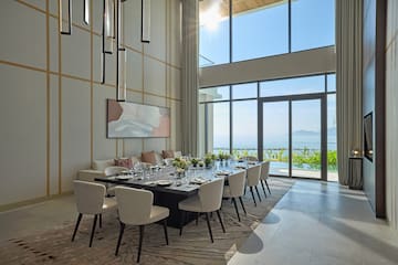 a dining room with a large table and chairs