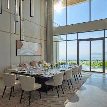 a dining room with a large table and chairs