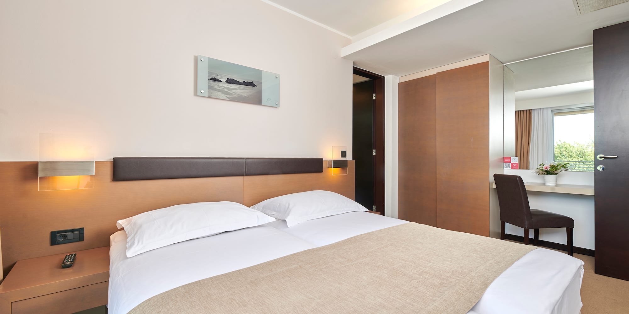 a bed with a brown blanket and a brown headboard