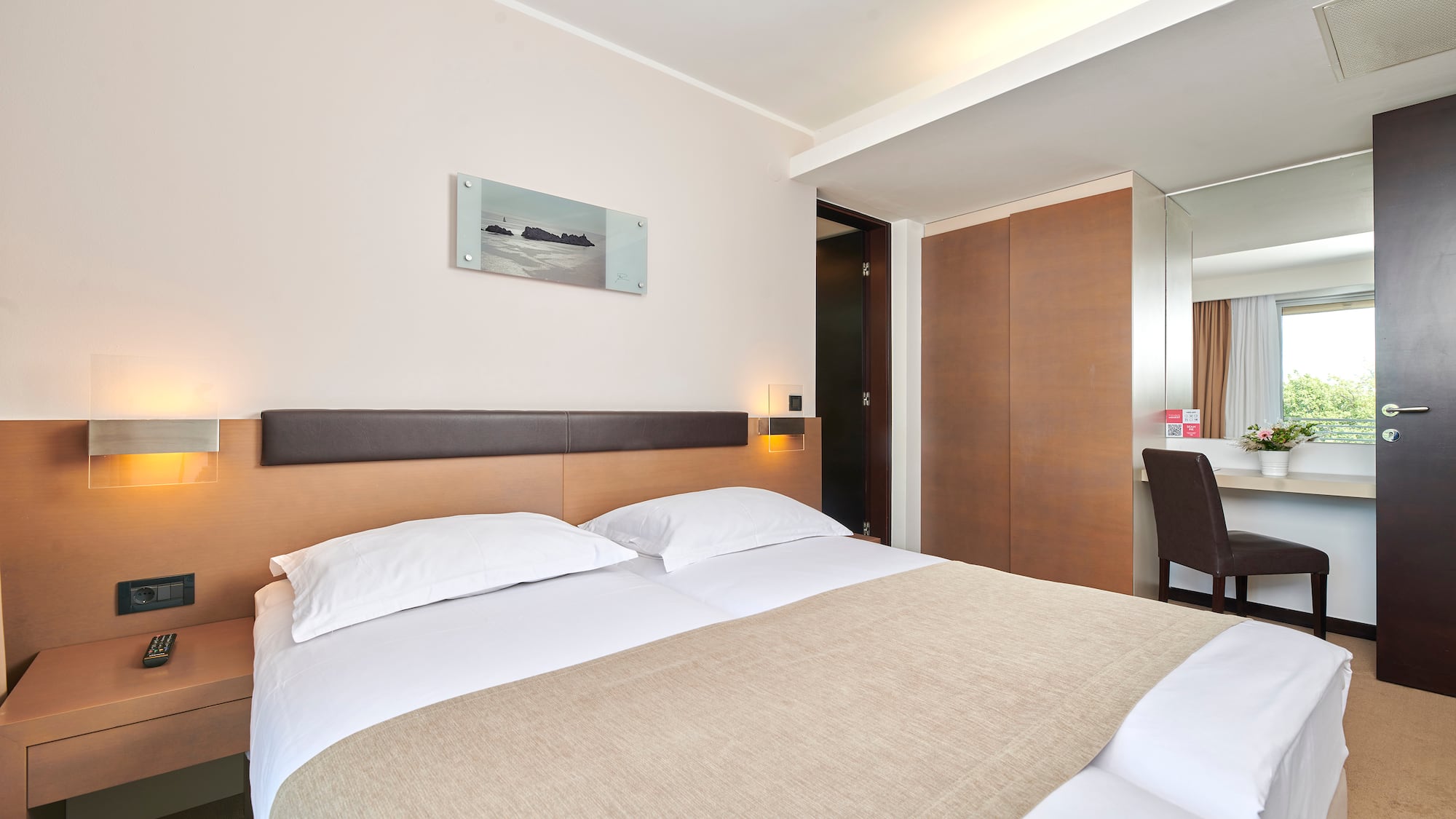 a bed with a brown blanket and a brown headboard