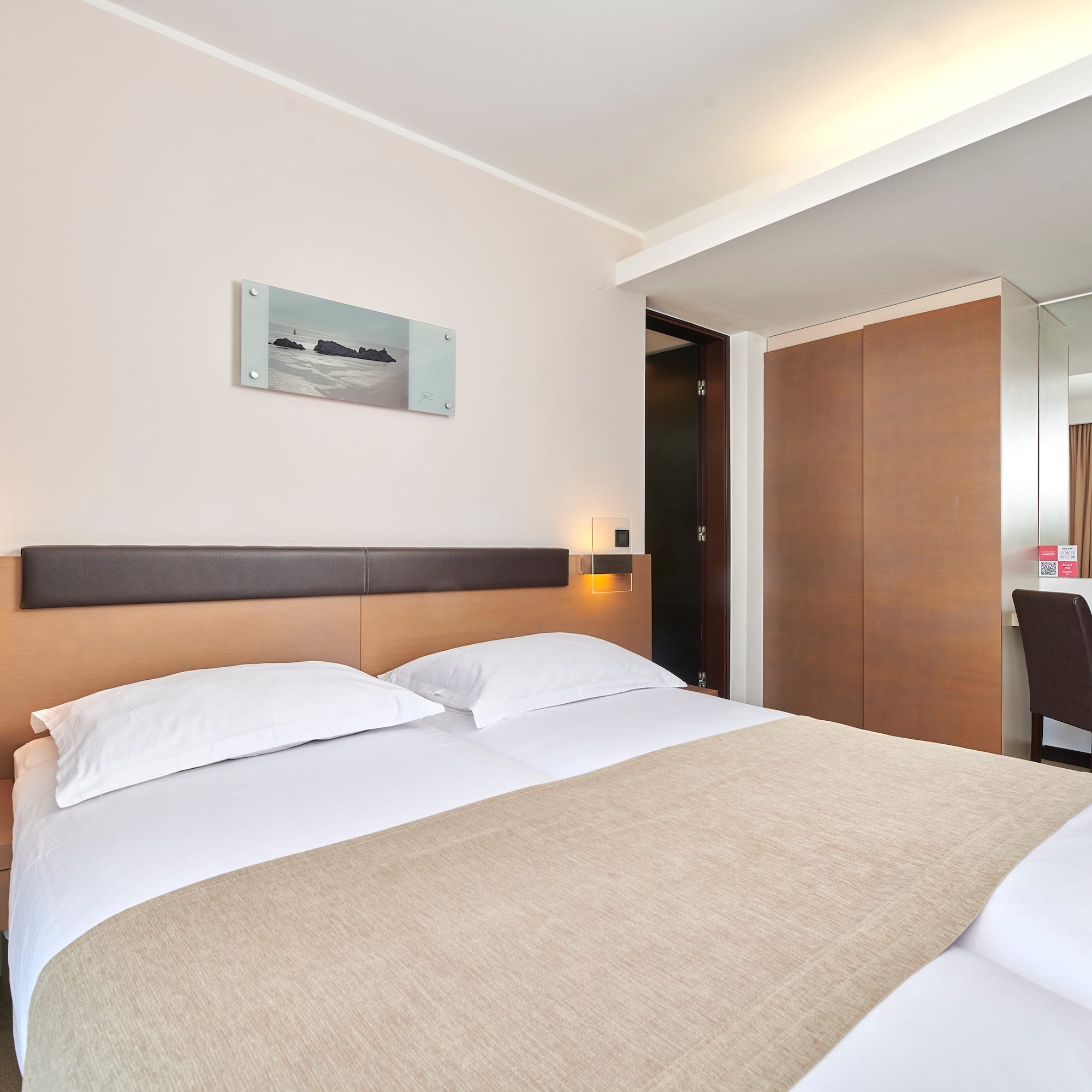 a bed with a brown blanket and a brown headboard