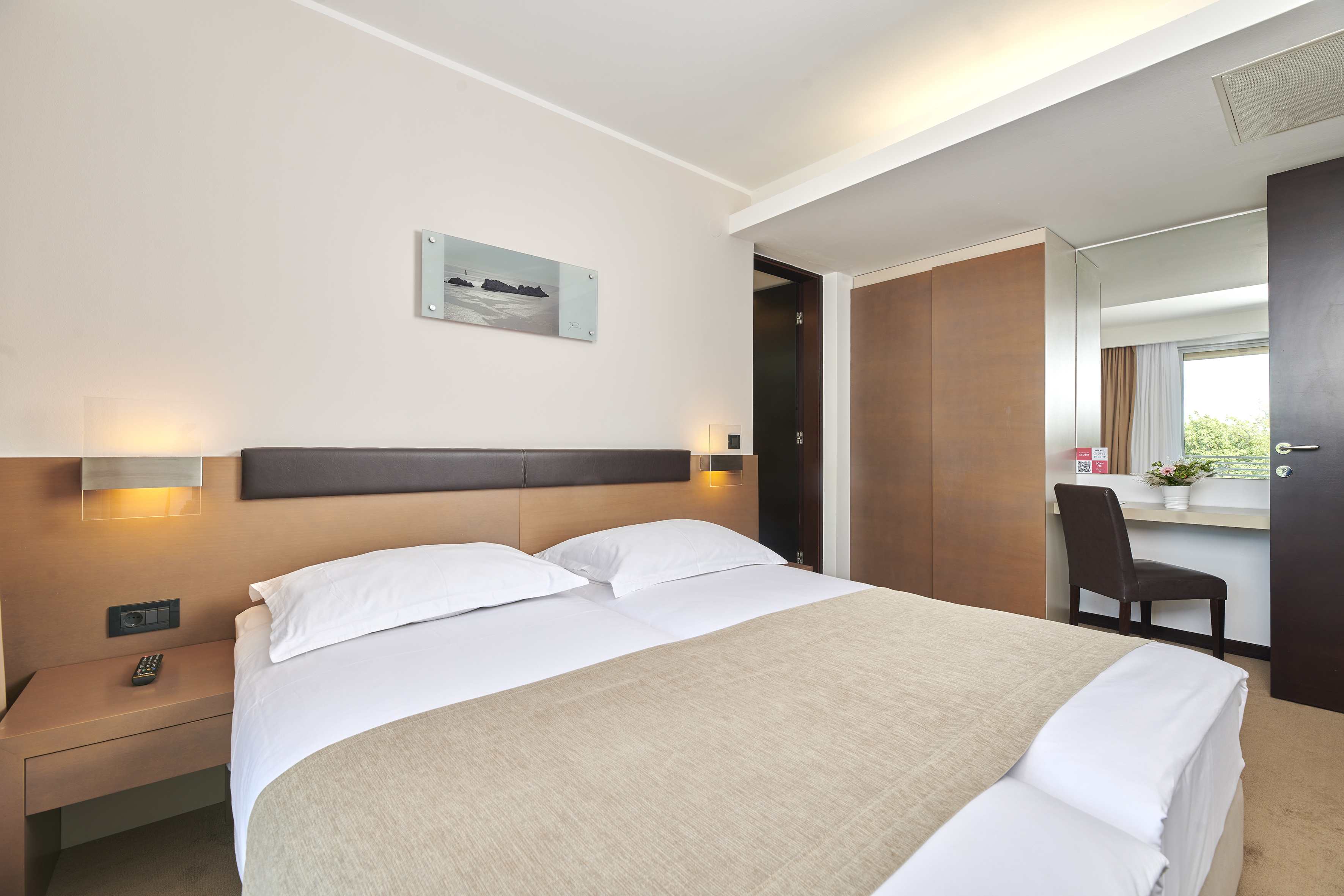 a bed with a brown blanket and a brown headboard