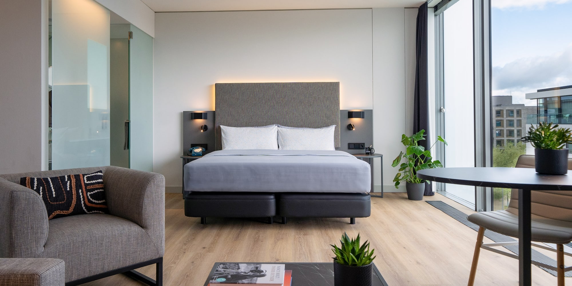 a room with a bed and chairs