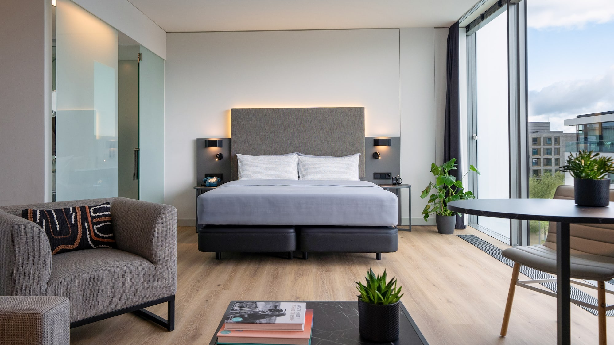 a room with a bed and chairs