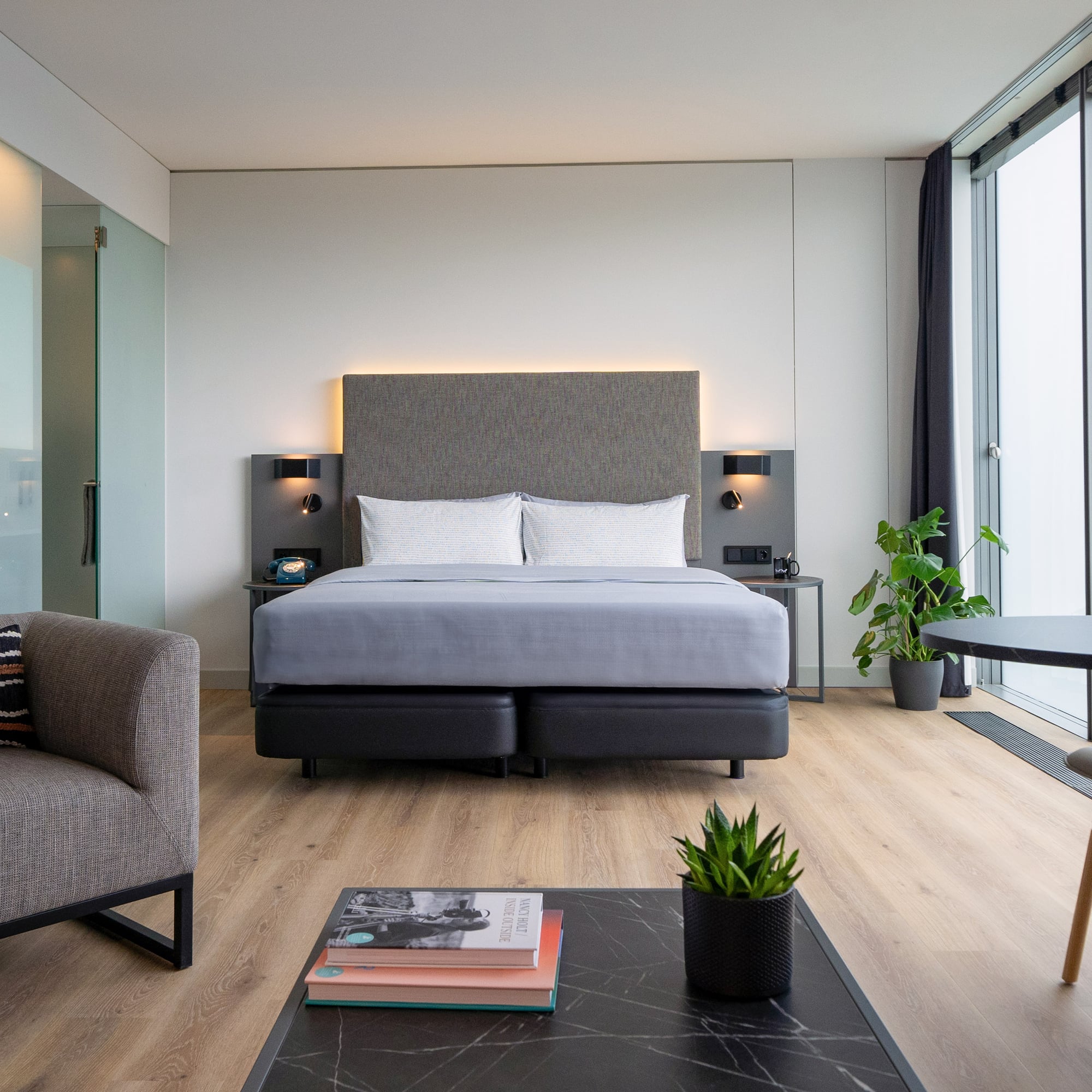 a room with a bed and chairs