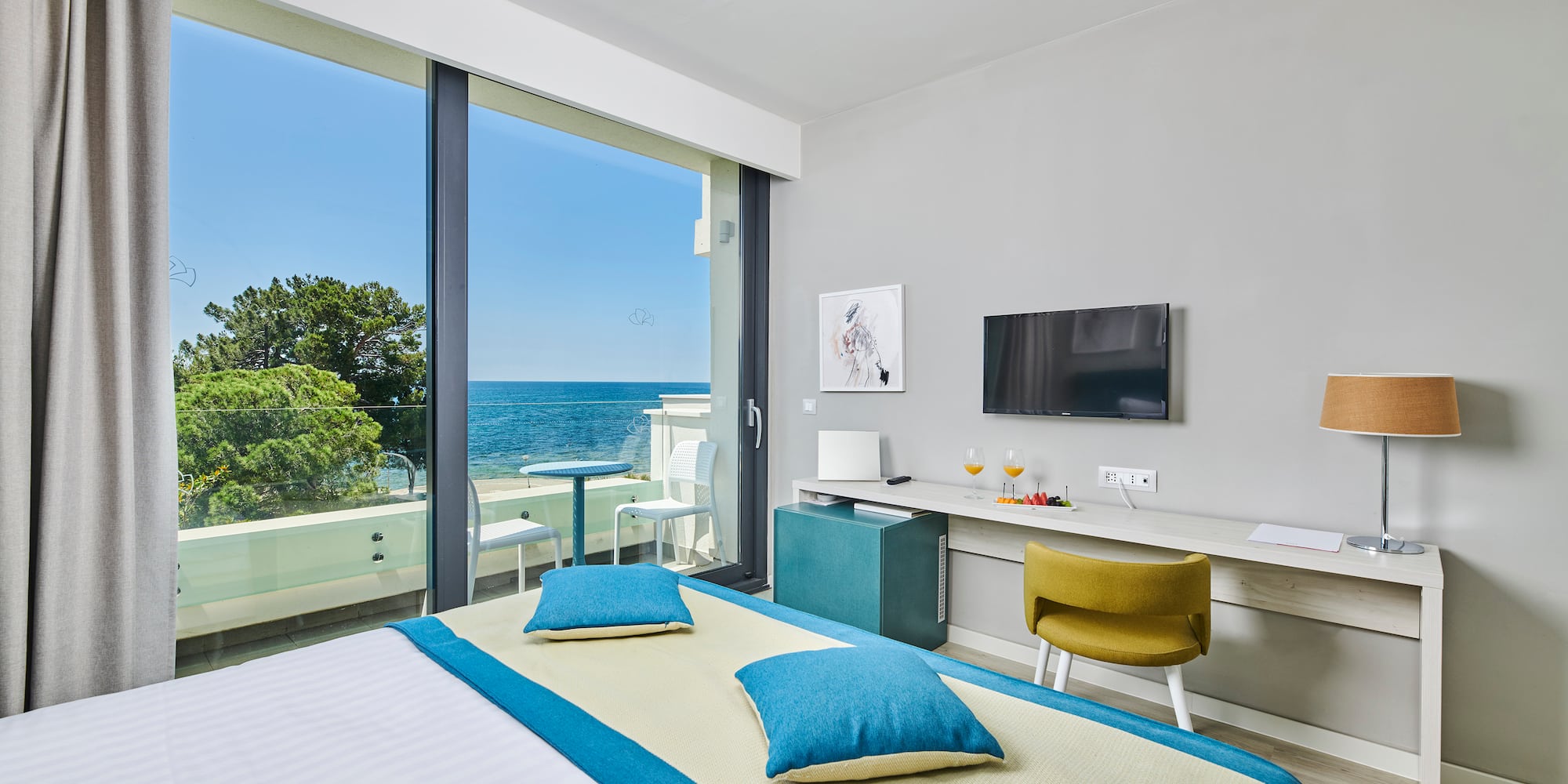 a room with a bed and a television and a table