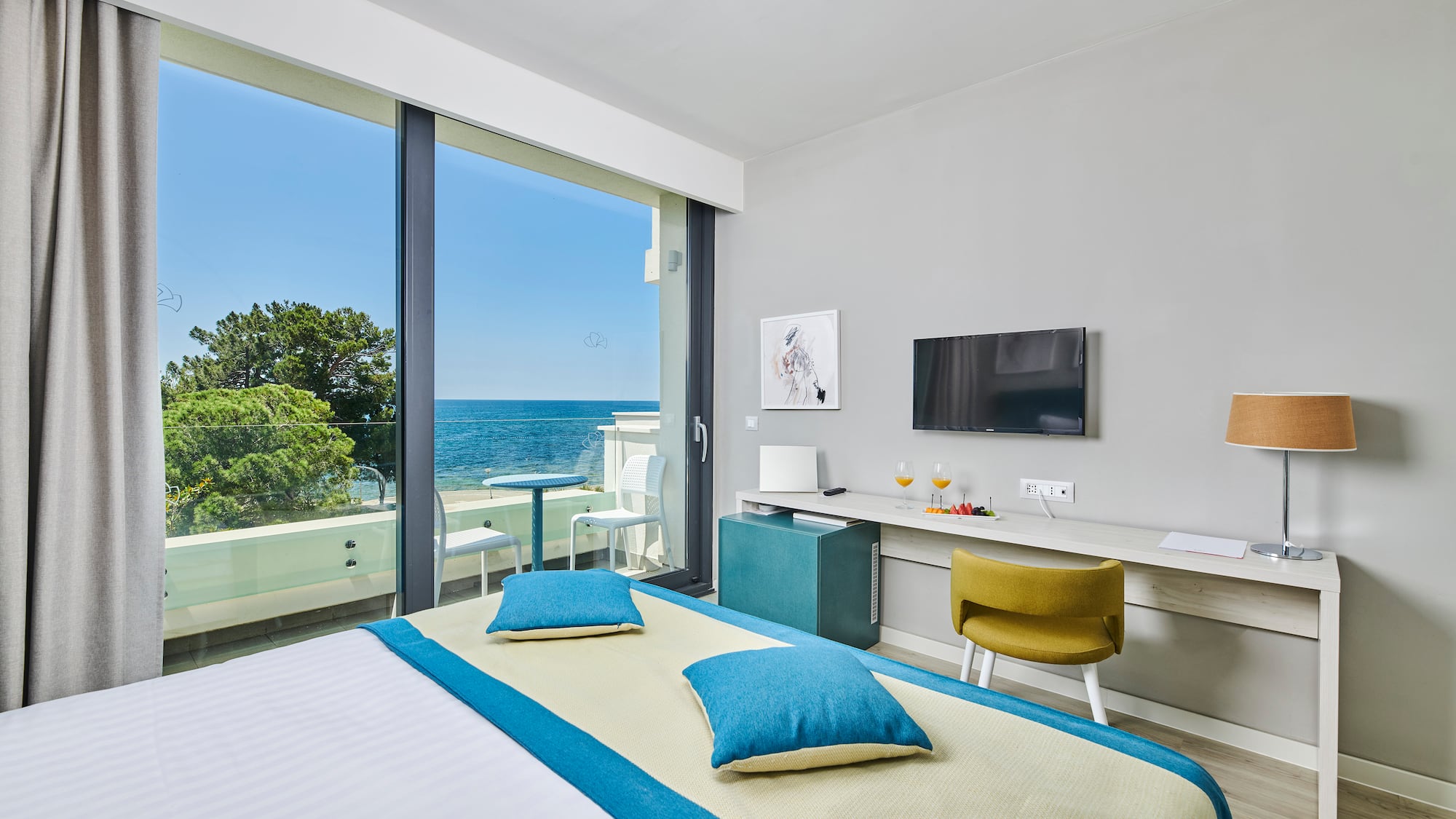 a room with a bed and a television and a table