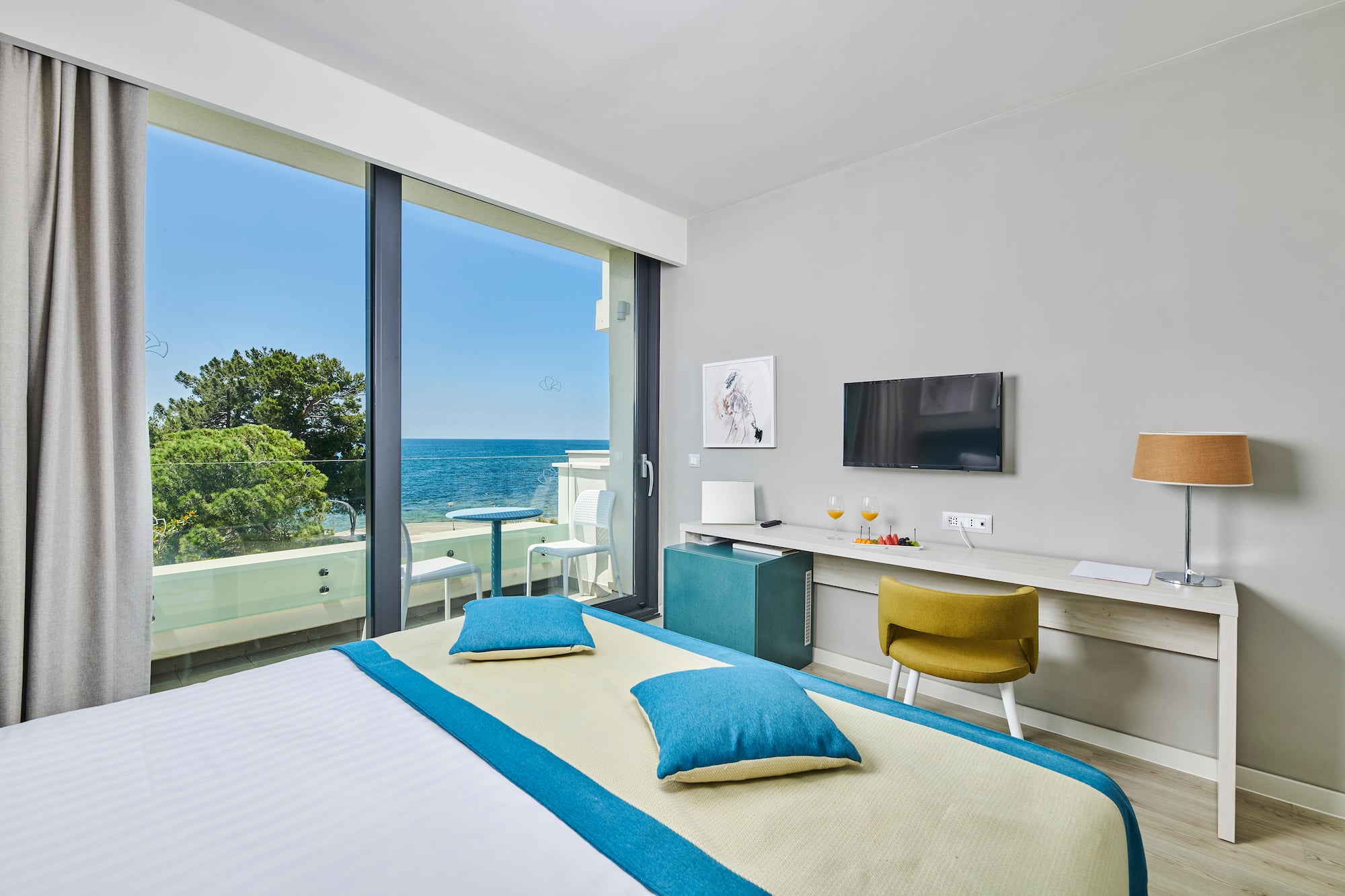 a room with a bed and a television and a table