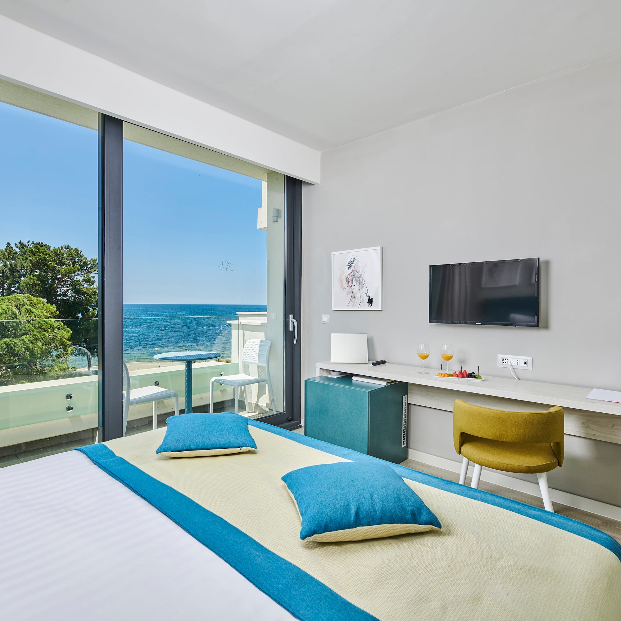 a room with a bed and a television and a table