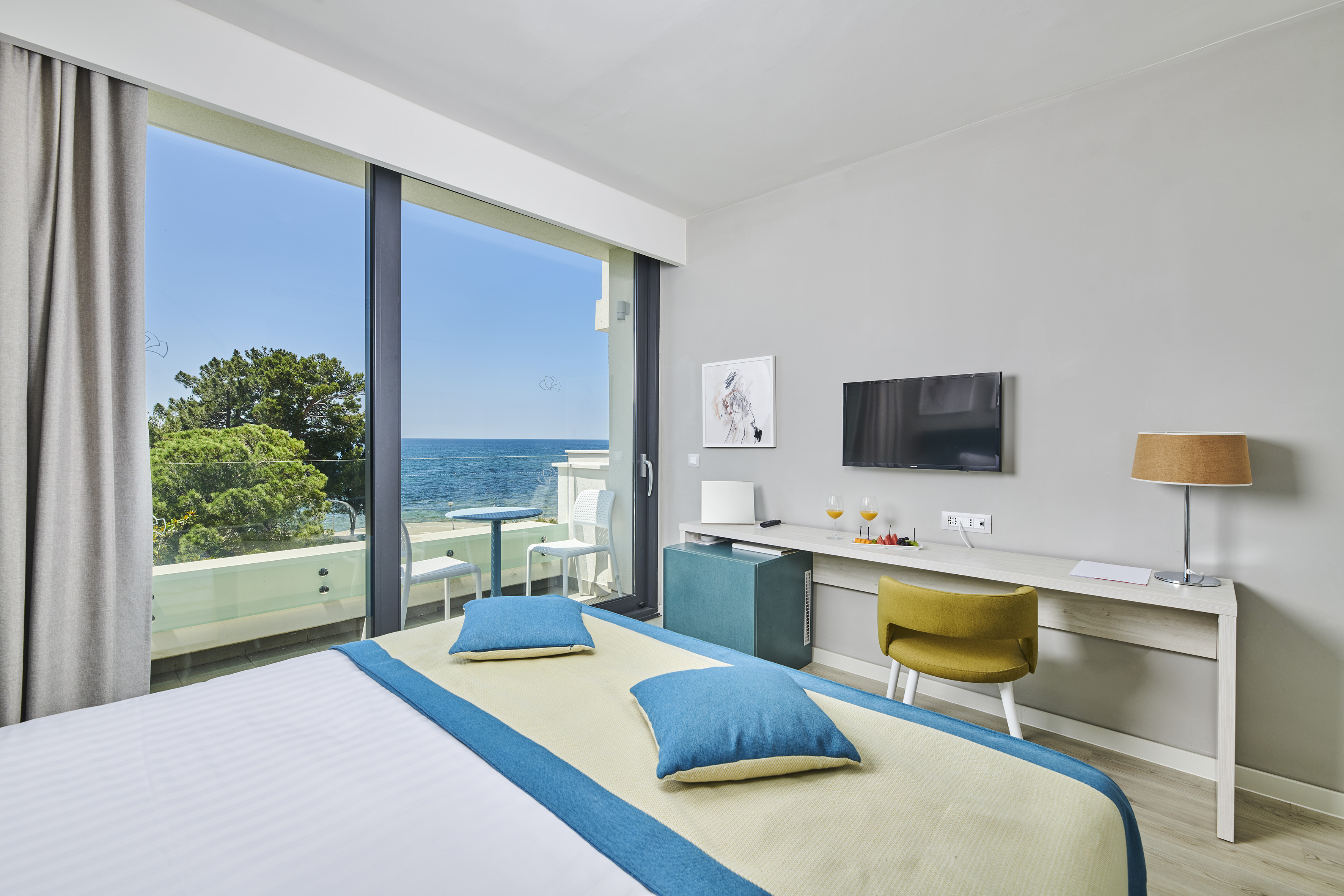 a room with a bed and a television and a table