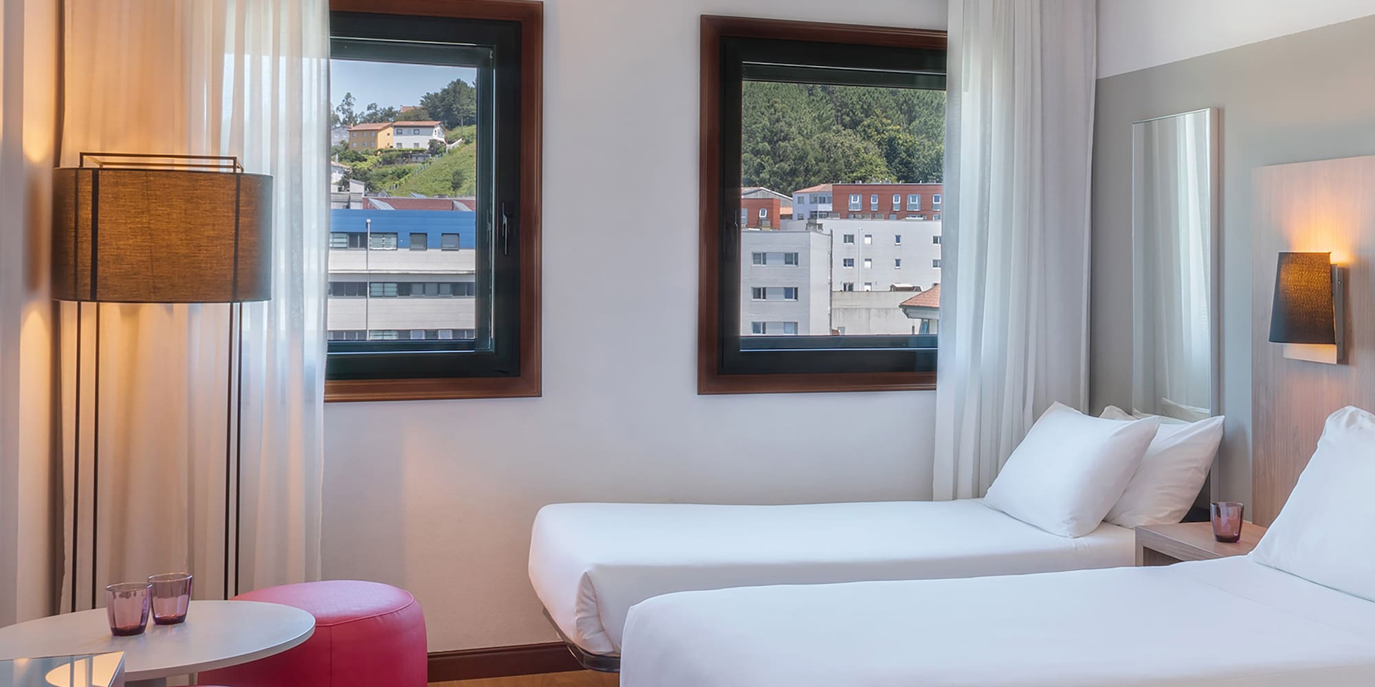 a room with two beds and a table