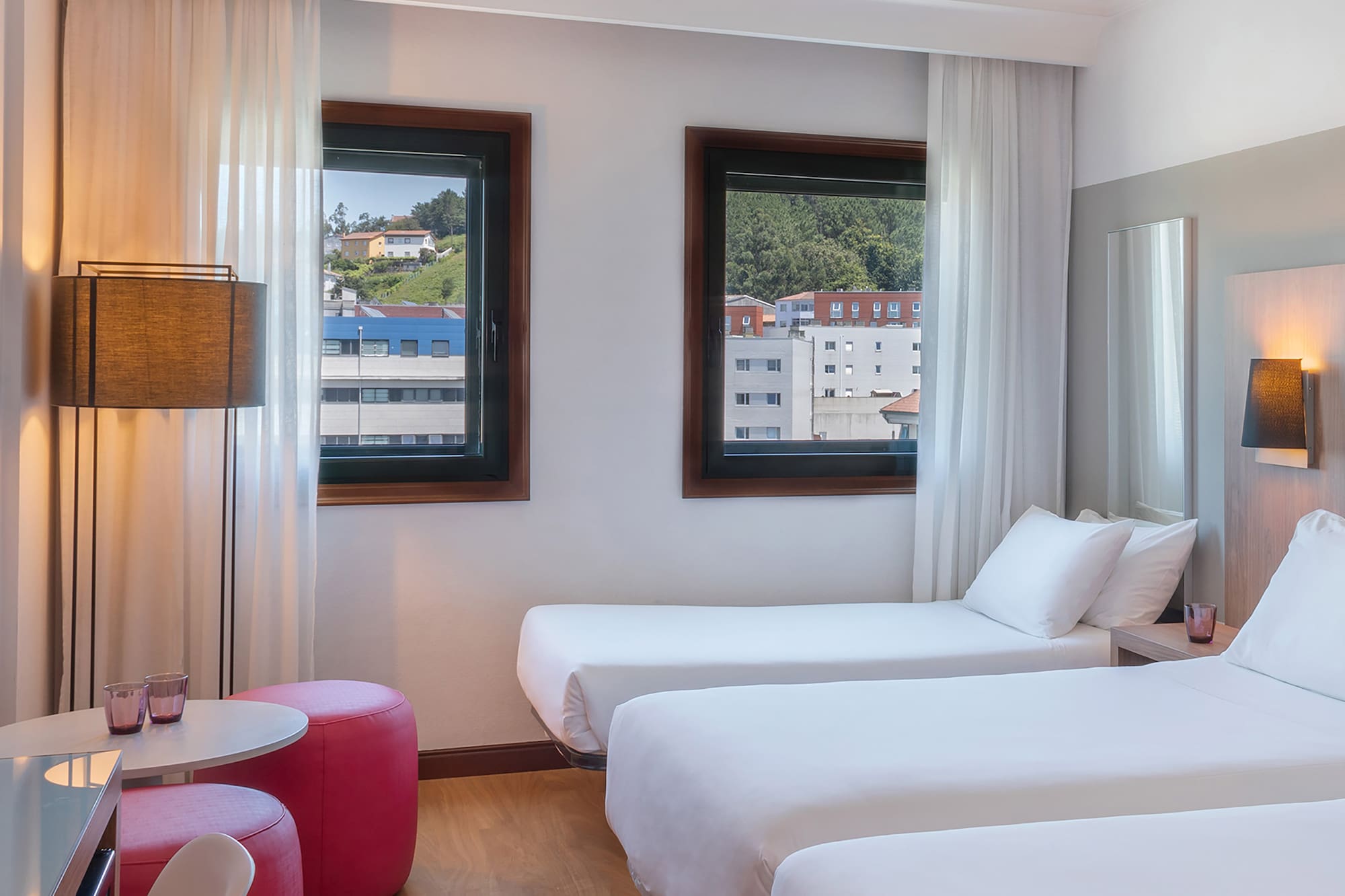 a room with two beds and a table